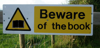 A picture of a sign that says Beware of the book