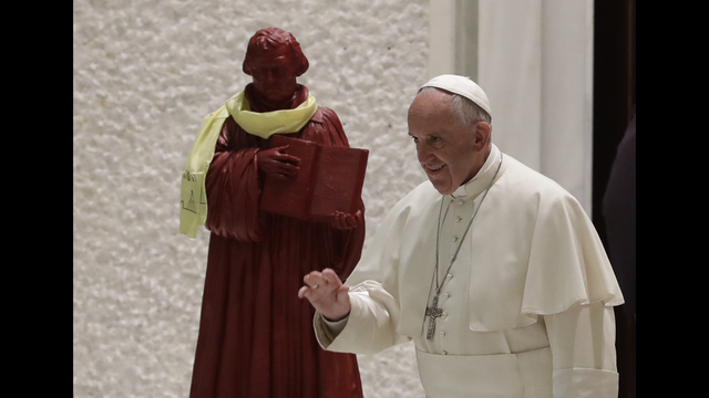 Pope Frances at the Vatican with a statue of Martin Luther