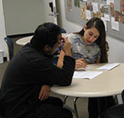 Image of two students studying at the writing center