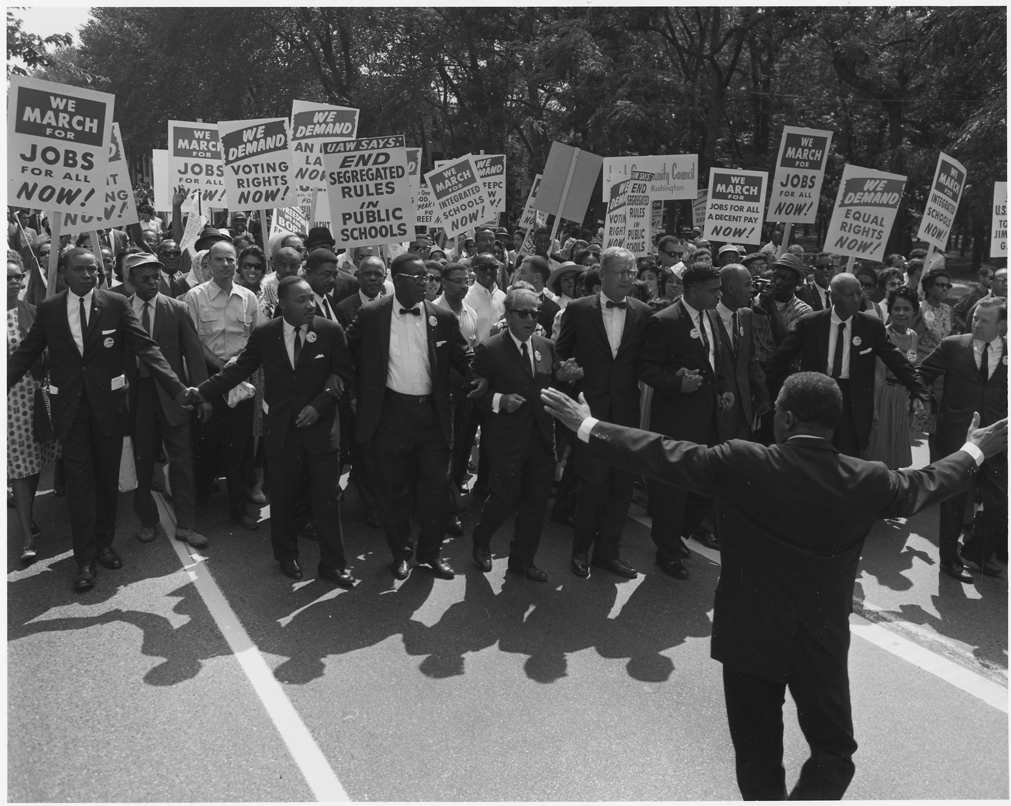 A march with posters for jobs, desegregated schools, voting rights, and more.