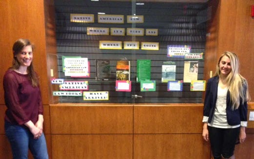 NALSA members stand with Native American legal materials display