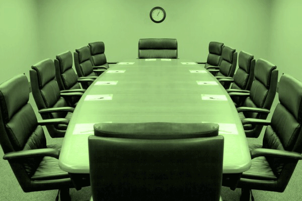 Image: a corporate boardroom table and chairs