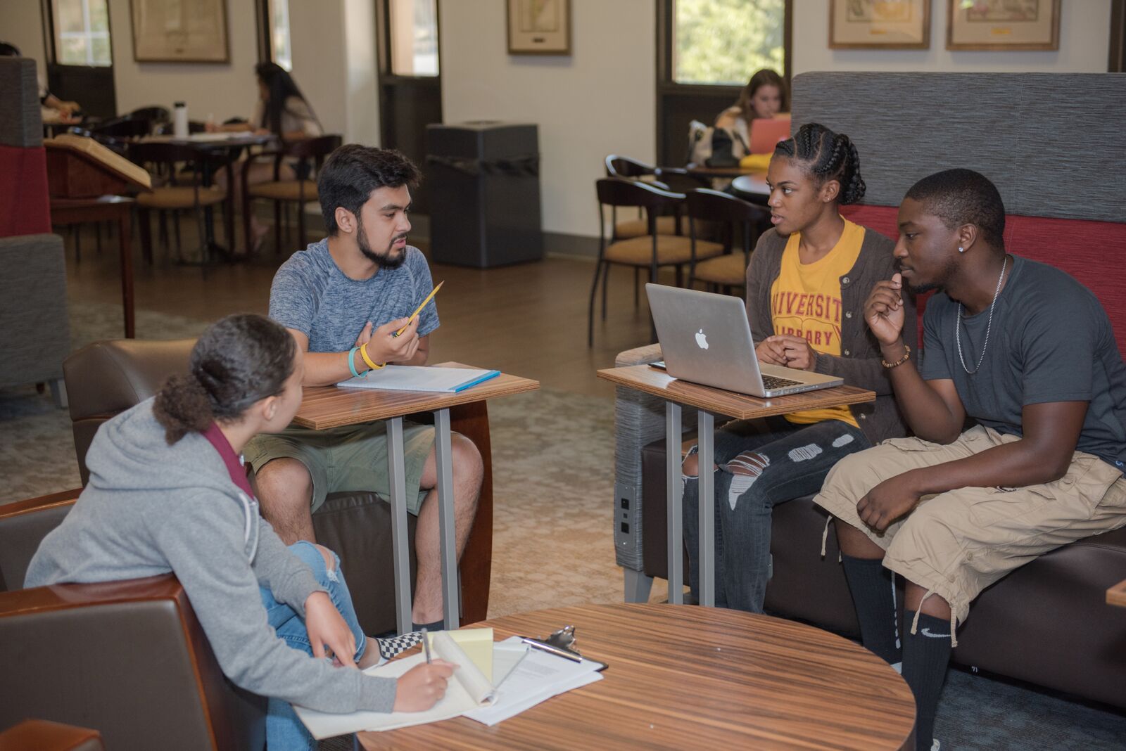 Students chatting in a circle in the Dominguez Den. 