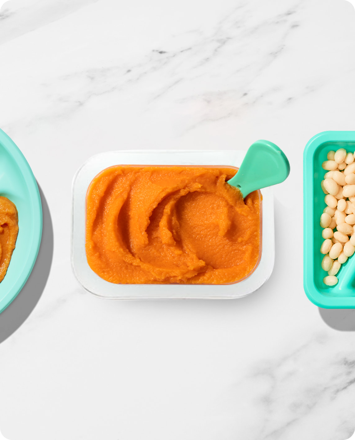 Little Spoon baby food blends displayed on a marble surface, featuring sweet potato blend with a teal spoon.