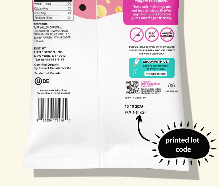 Back of a Little Spoon Puffs bag showing the printed lot code above the barcode, with a label pointing to the lot code.