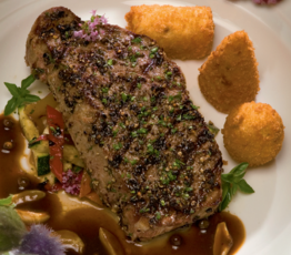 Smokey Mountain Strip Loin with Dauphine Potatoes and Roasted Garlic Herb Jus