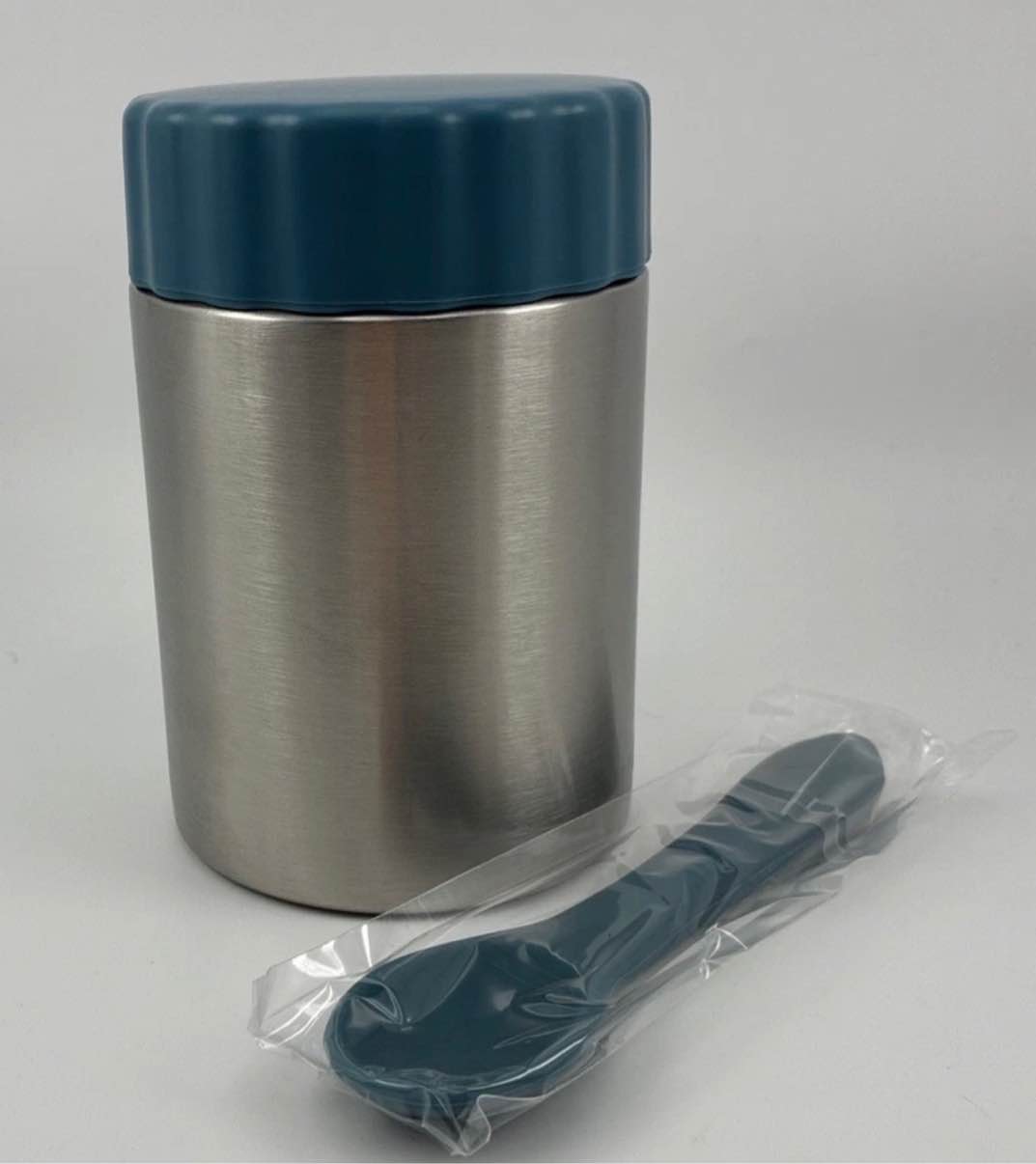 Condition photo showing Brand New for earth made stainless steel food jar ceramic interior with silicone spoon blue