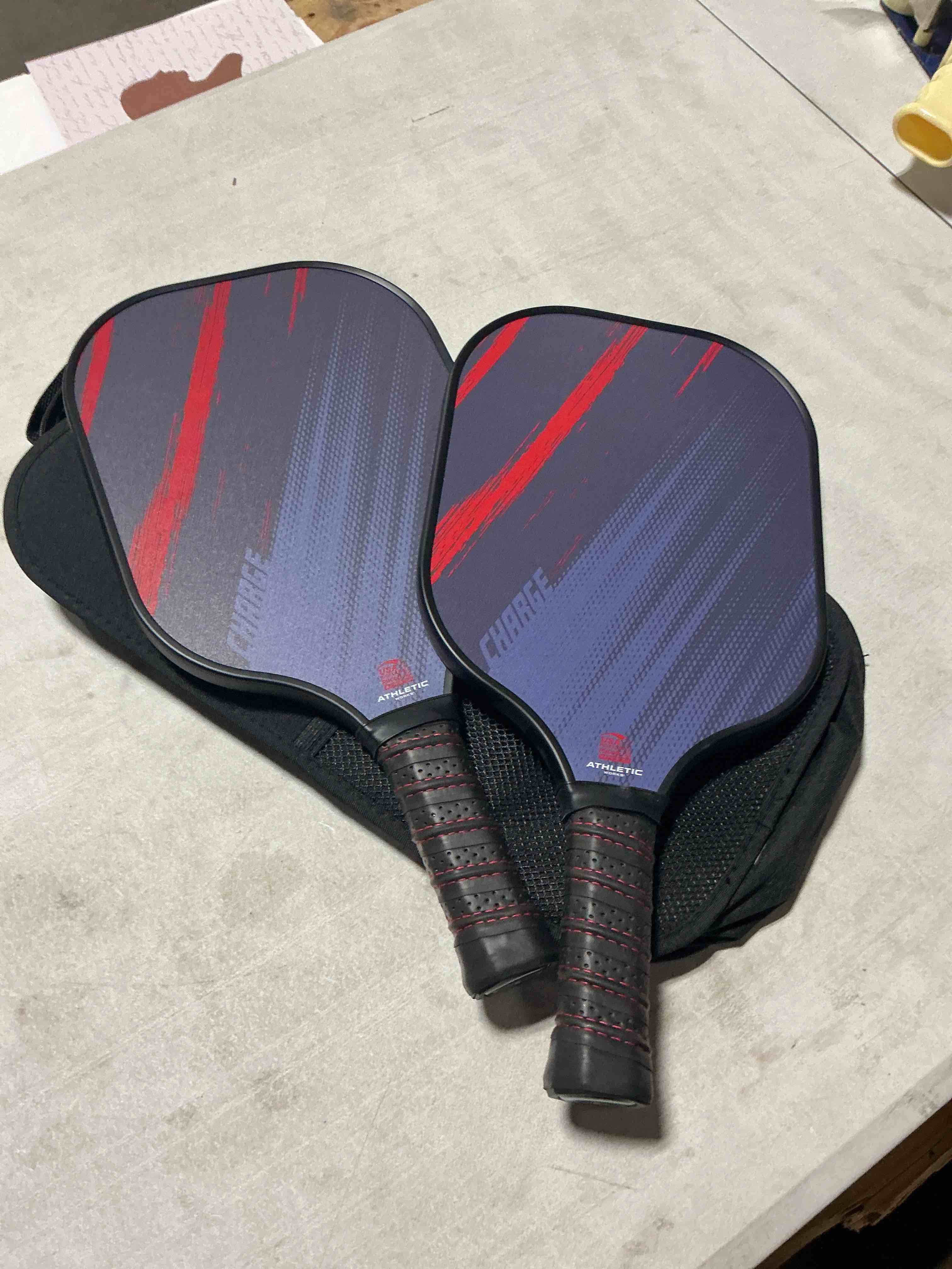 Condition photo showing New/Like New for athletic works charge fiberglass 2-player pickleball paddle set, includes 2 paddles, carry bag, red