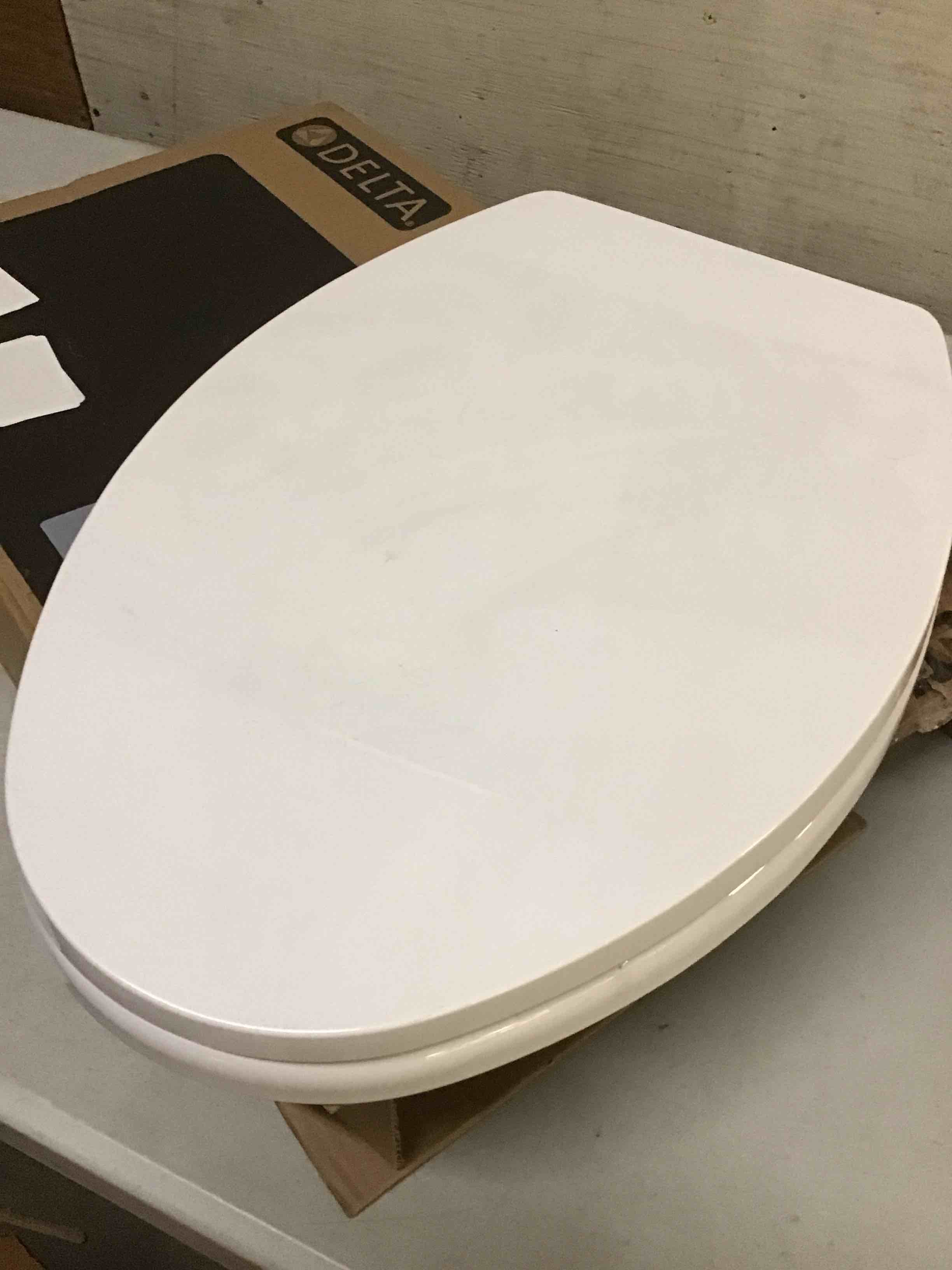 Condition photo showing As Is for ( incomplete) delta 833004 elongated soft close bidet seat with manual control self-cleaning wand - white transitional