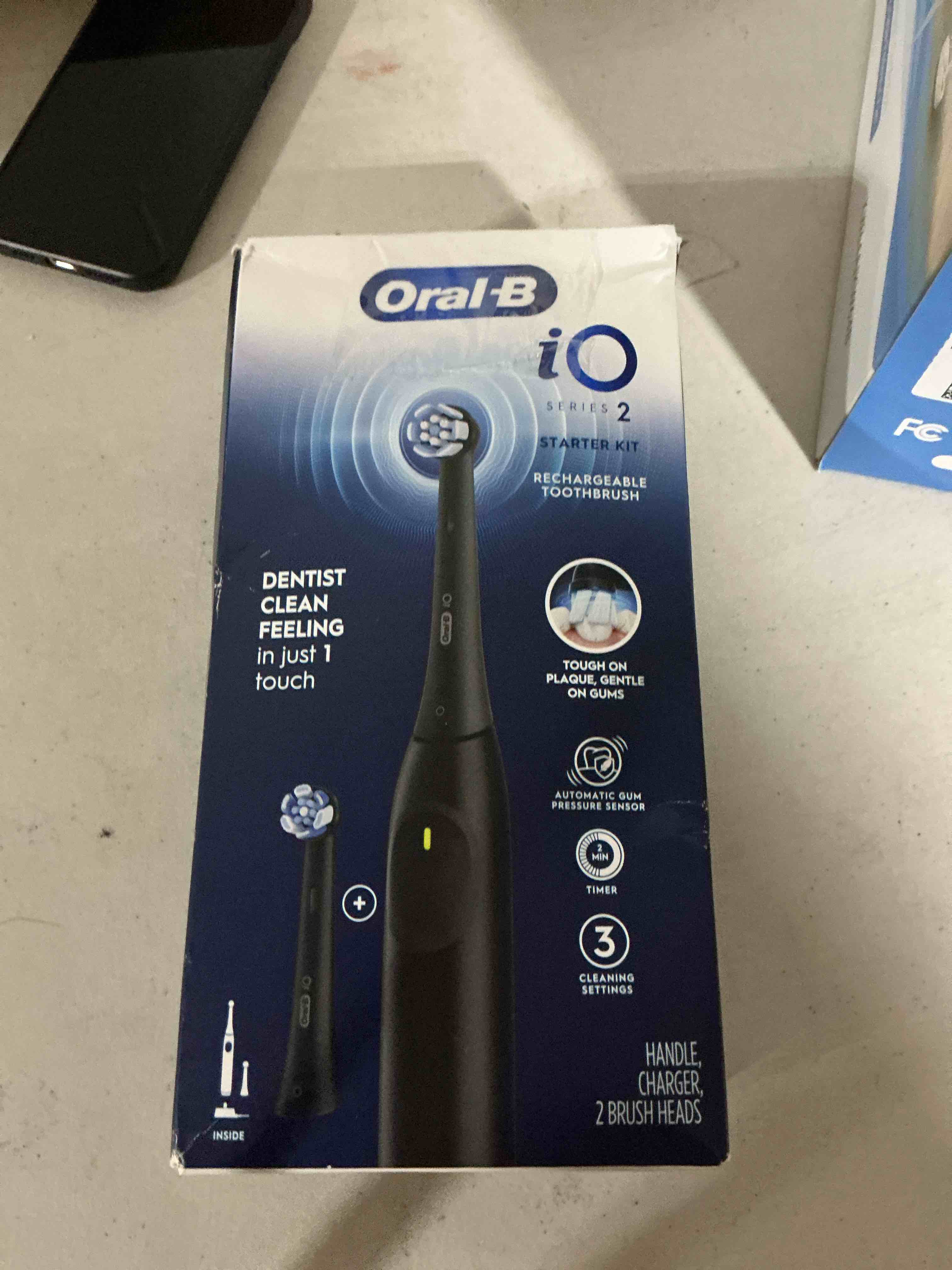 Condition photo showing As Is for oral-b rechargeable electric toothbrush, io2 starter kit, 3 cleaning modes, automatic pressure sensor to protect gums, 2 brush heads, night black night black 1 count (pack of 1)