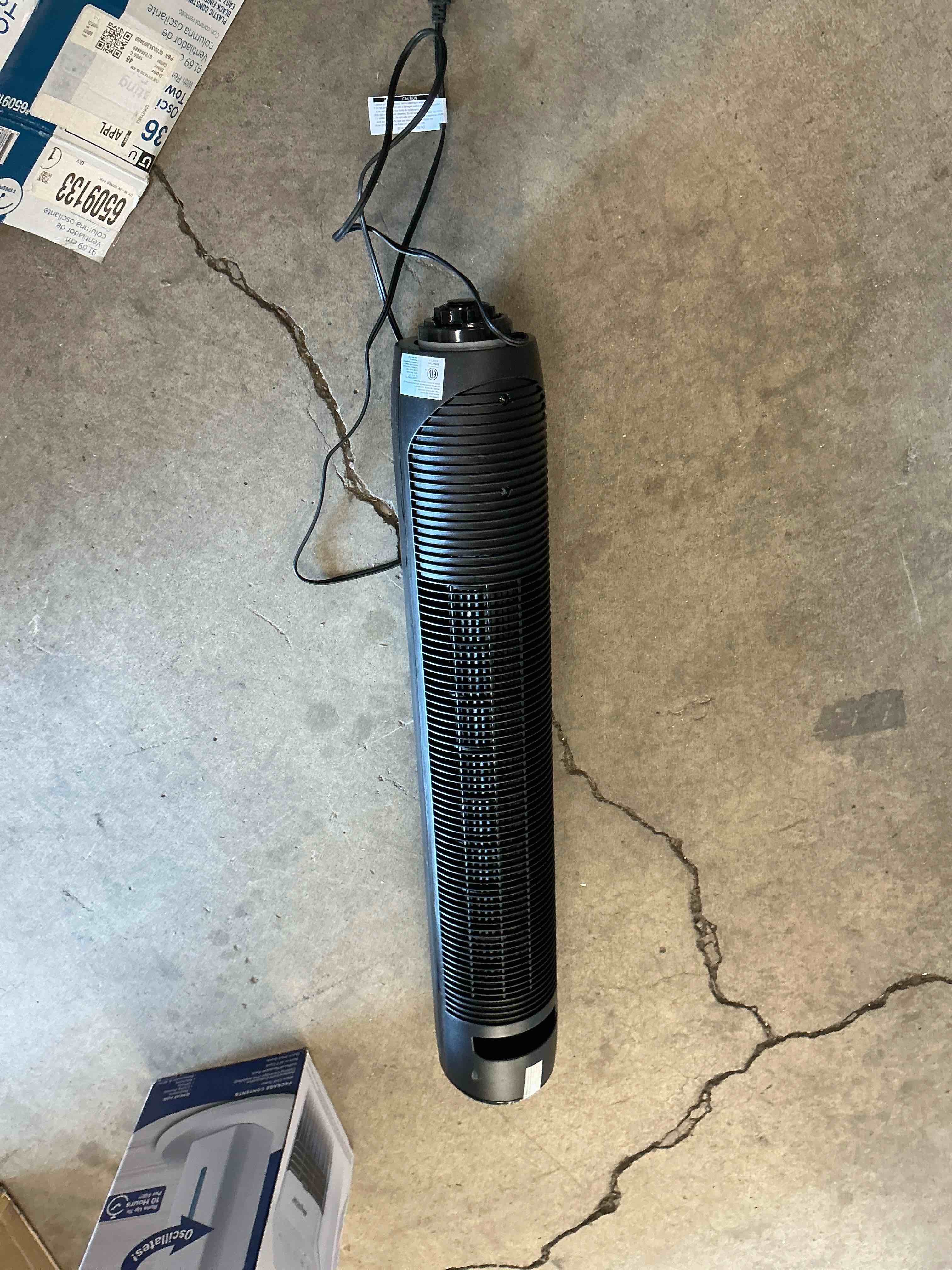 Condition photo showing As Is for  utilitech 36-in indoor oscillating tower fan, in black/matte with remote