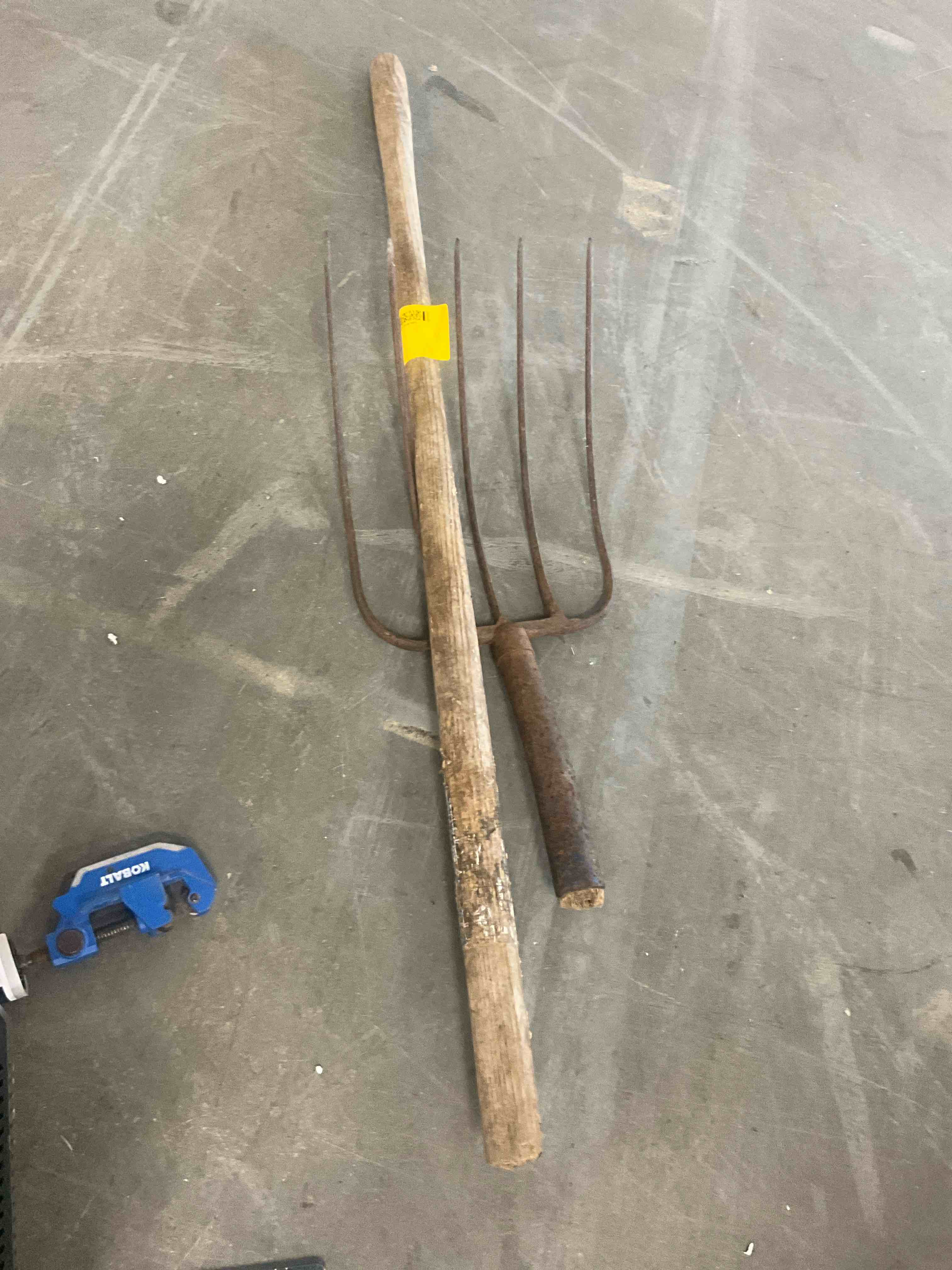 Condition photo showing As Is for wood -handle steel manure fork