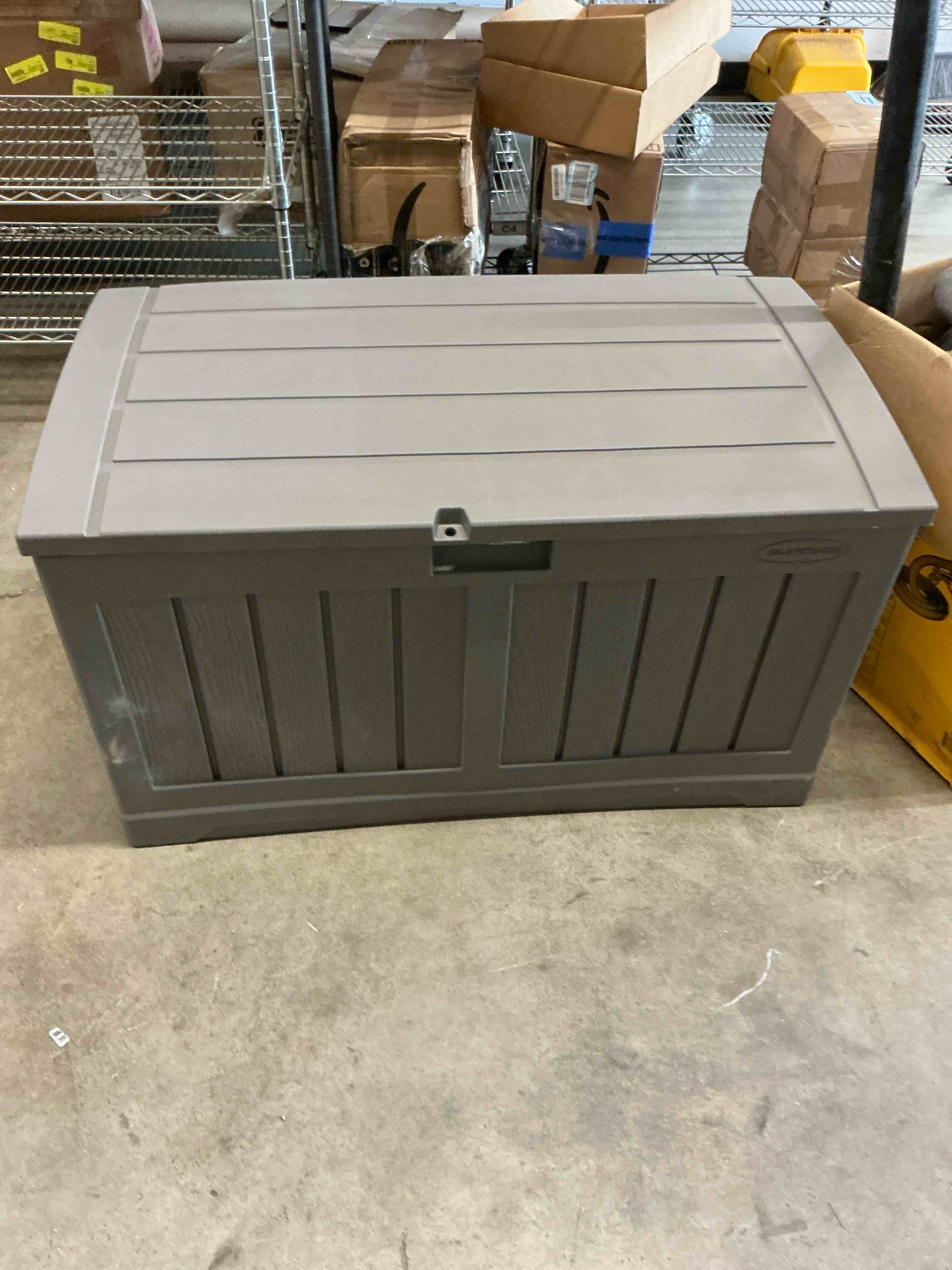 Condition photo showing Good Condition for suncast 50 gallon plastic deck box with molded lockable feature and weathertight construction for home, patio, lawn, and garden storage, gray