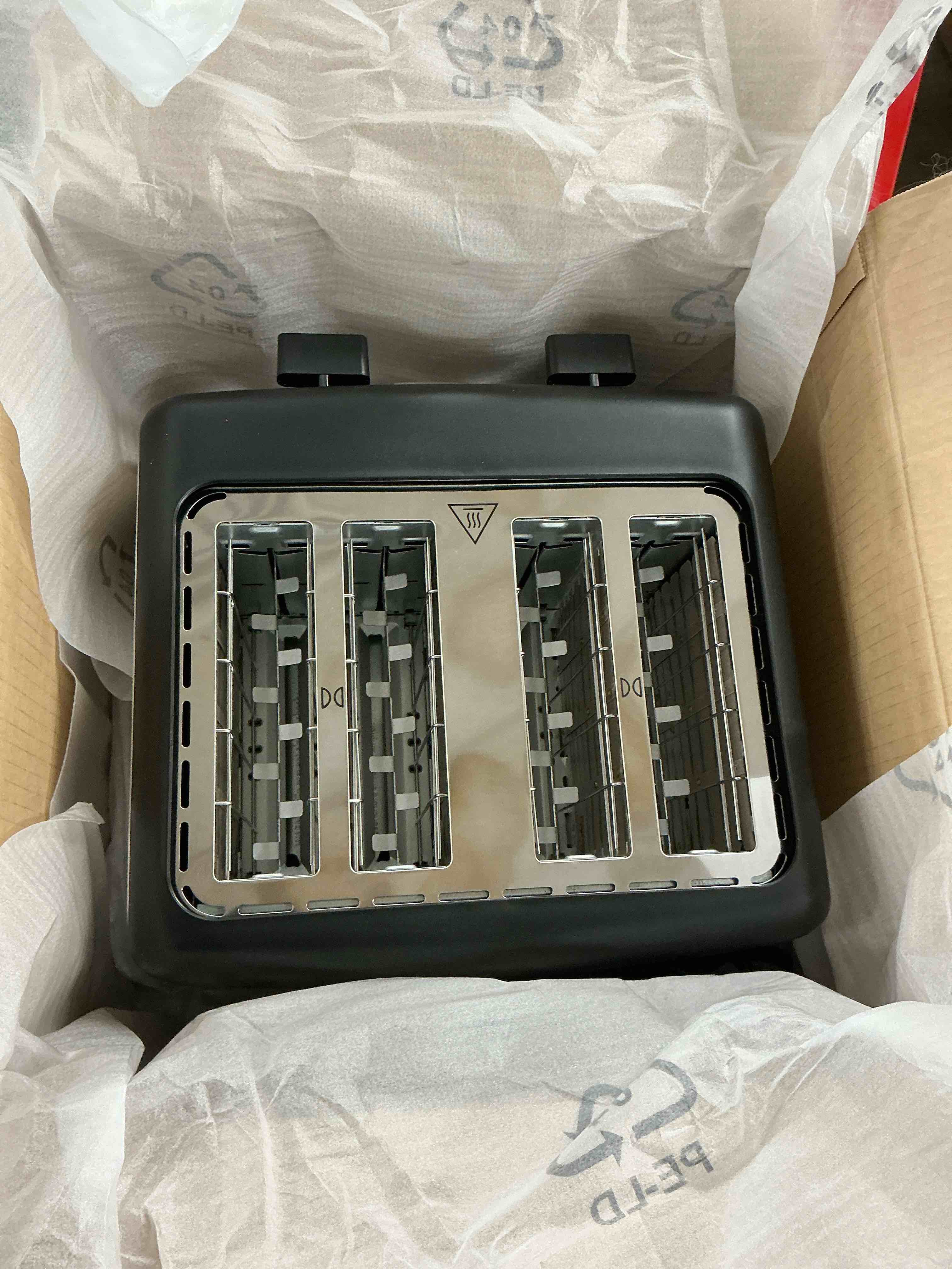 Condition photo showing New/Like New for amazon basics 4 slice toaster, with 7 browning settings, extra wide slots for bagels and special breads, removable easy-to-clean crumb trays, cancel/defrost/bagel buttons, 1500w, black & silver 4 slice matte black front