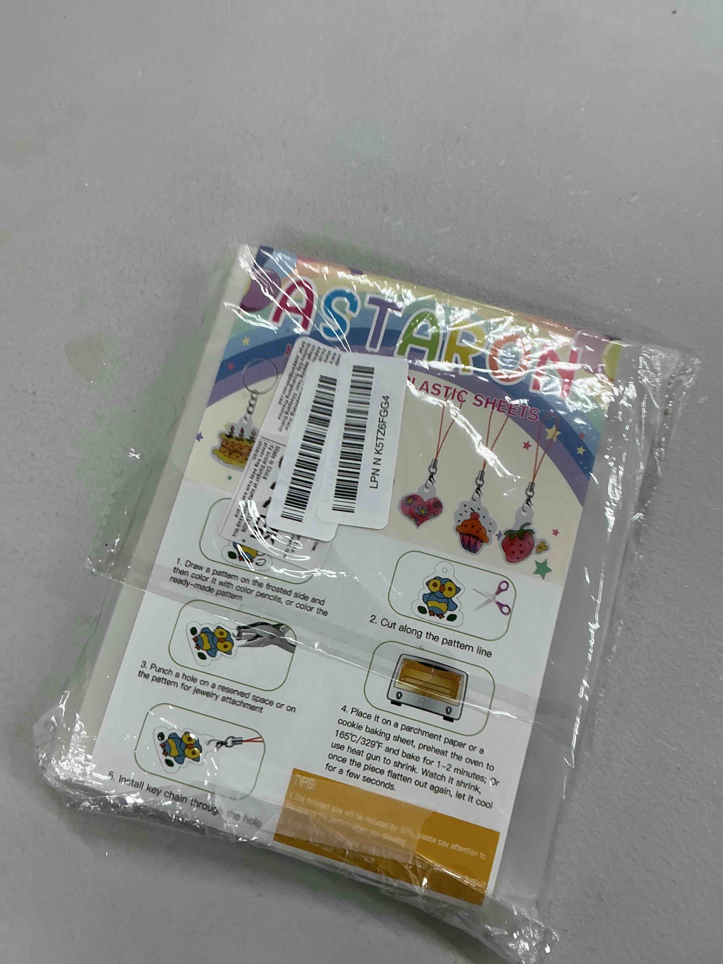 Condition photo showing Good Condition for ASTARON 168Pcs Shrinking Plastic Sheets Kit Includes 15 Shrinking Film Art Paper, Hole Punch, 140 Pcs Shrinkles Keychain Jewelry Making Accessories for Kids Craft Supplies printed
