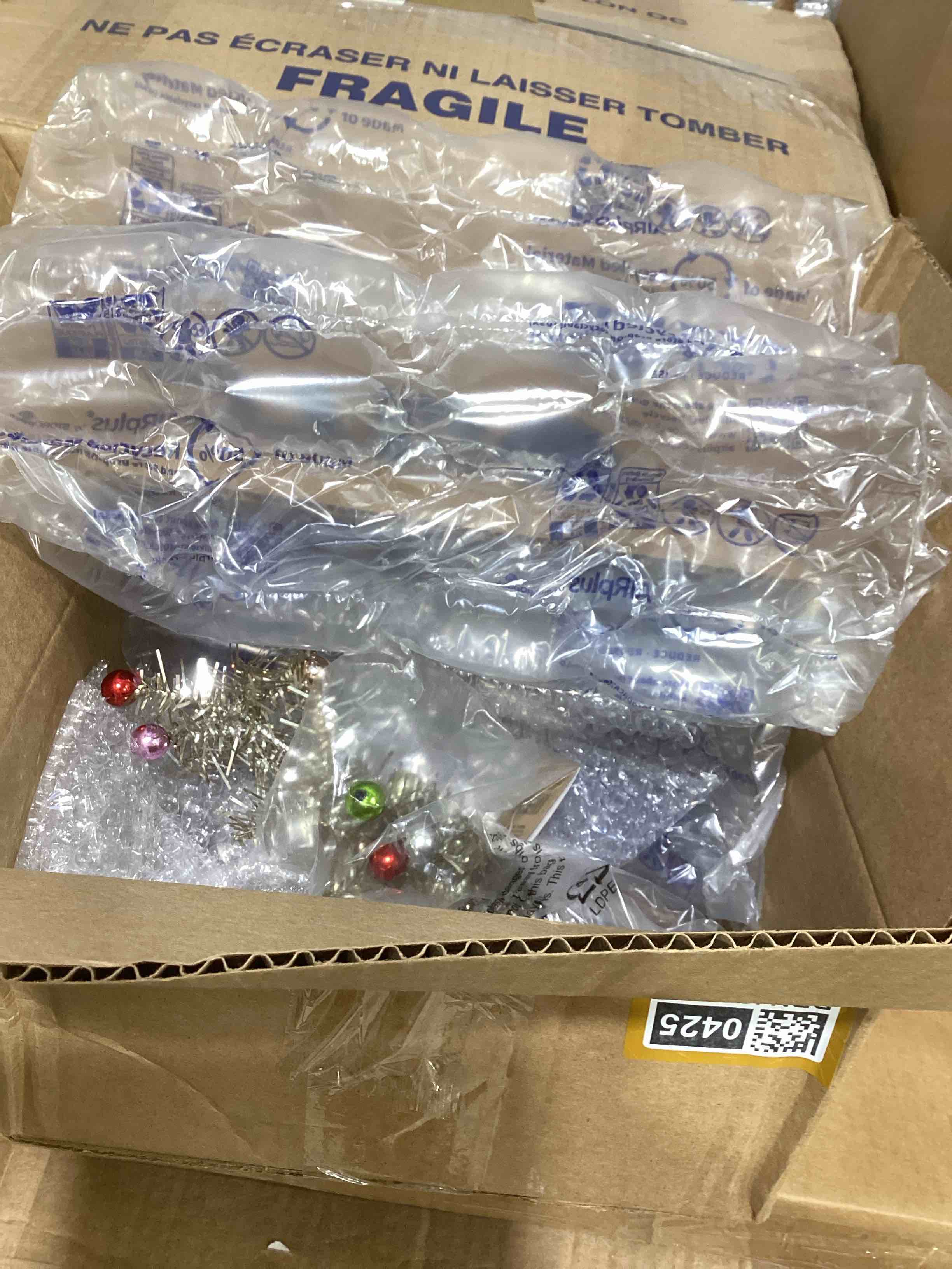 Condition photo showing New/Like New for tinsel tree with multicolor ball ornaments