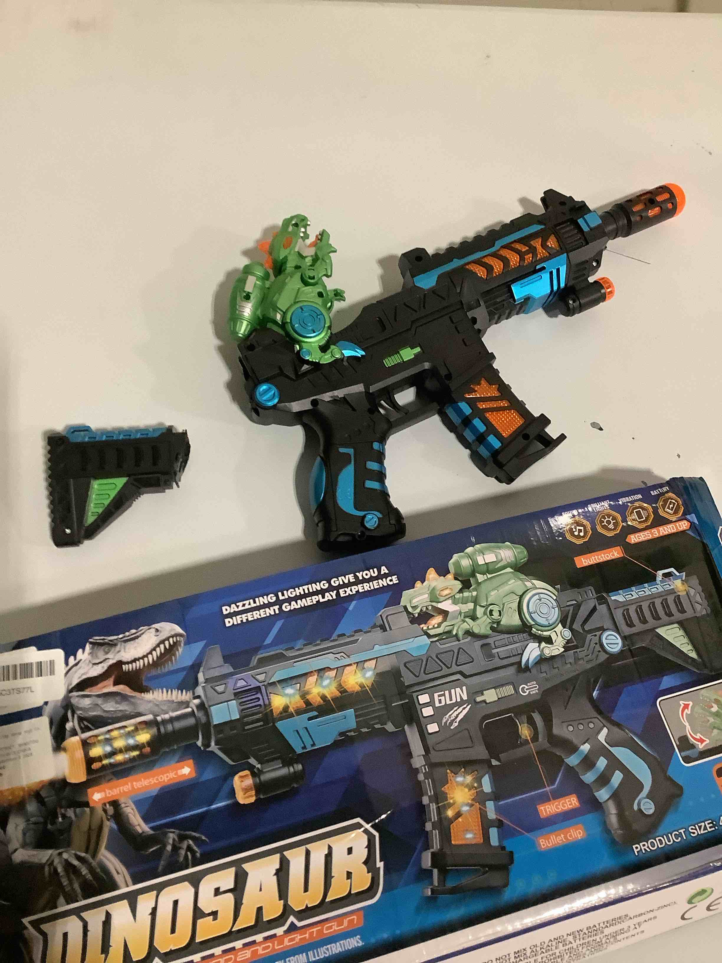 Condition photo showing As Is for Light Up Toy Gun with Sound Effects for Kids, Unique Barrel Telescopic Action & Liftable Dinosaur Baby Toy Guns Make Noise, Christmas Birthday Gifts for Boys Girls(Batteries Not Included) Black-green