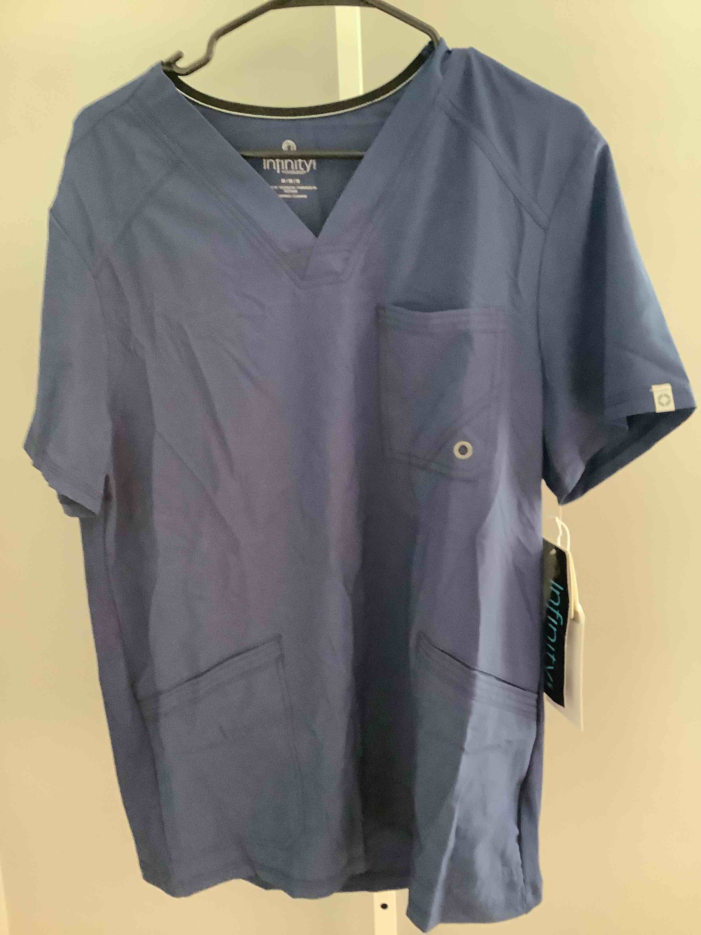 Condition photo showing New/Like New for color blue size medium cherokee infinity mens v-neck scrub top modern fit, 3 pockets, rib-knit back panels, moisture-wicking 360° stretch – ck900a