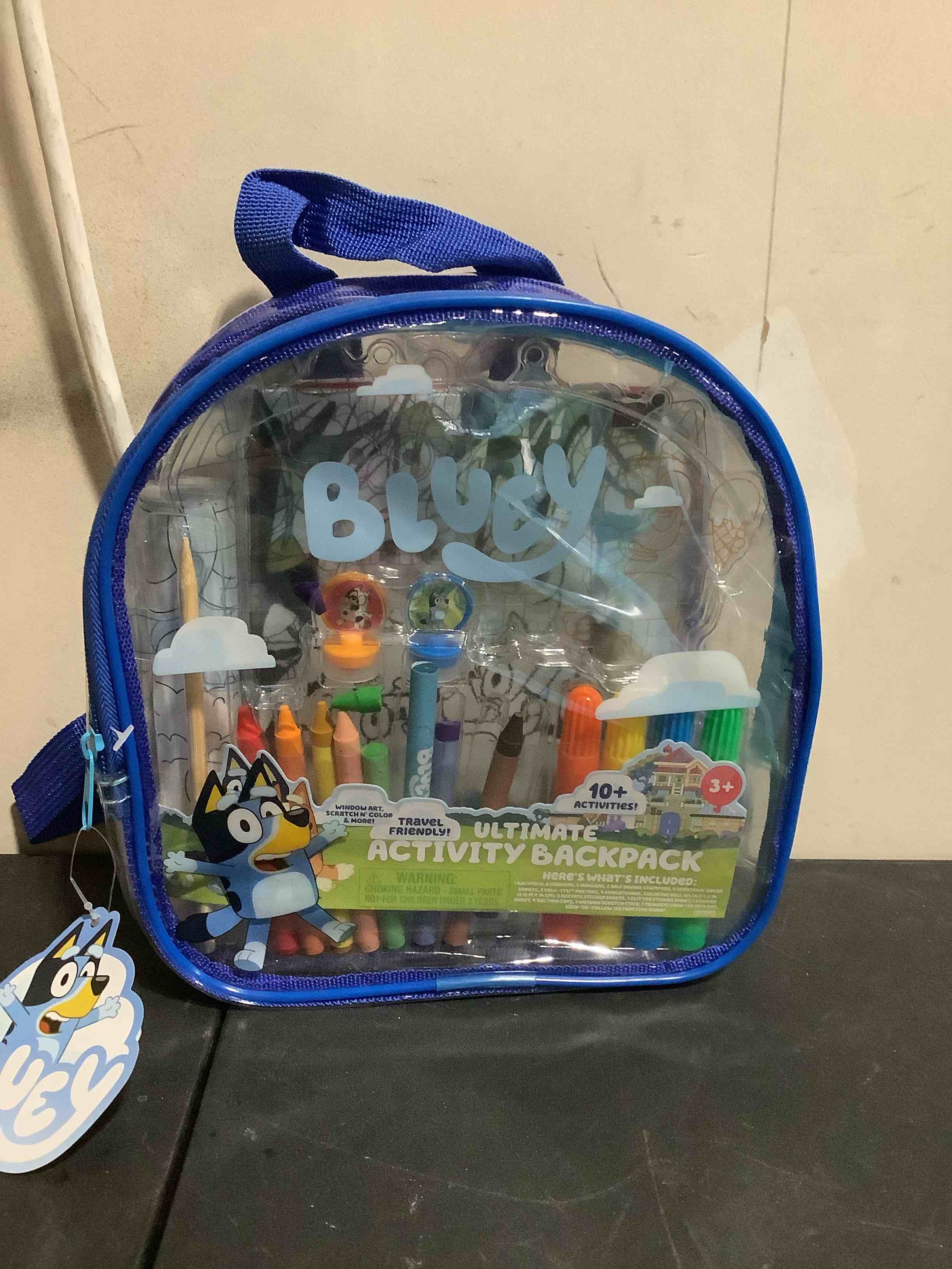 Condition photo showing New/Like New for bluey ultimate activity backpack, 10+ activities, includes backpack with 4 sticker suncatchers with 4 suction cups, 4 surprise scratch arts, 2 velv-its posters, 1 coloring roll, 4 markers, kid gifts
