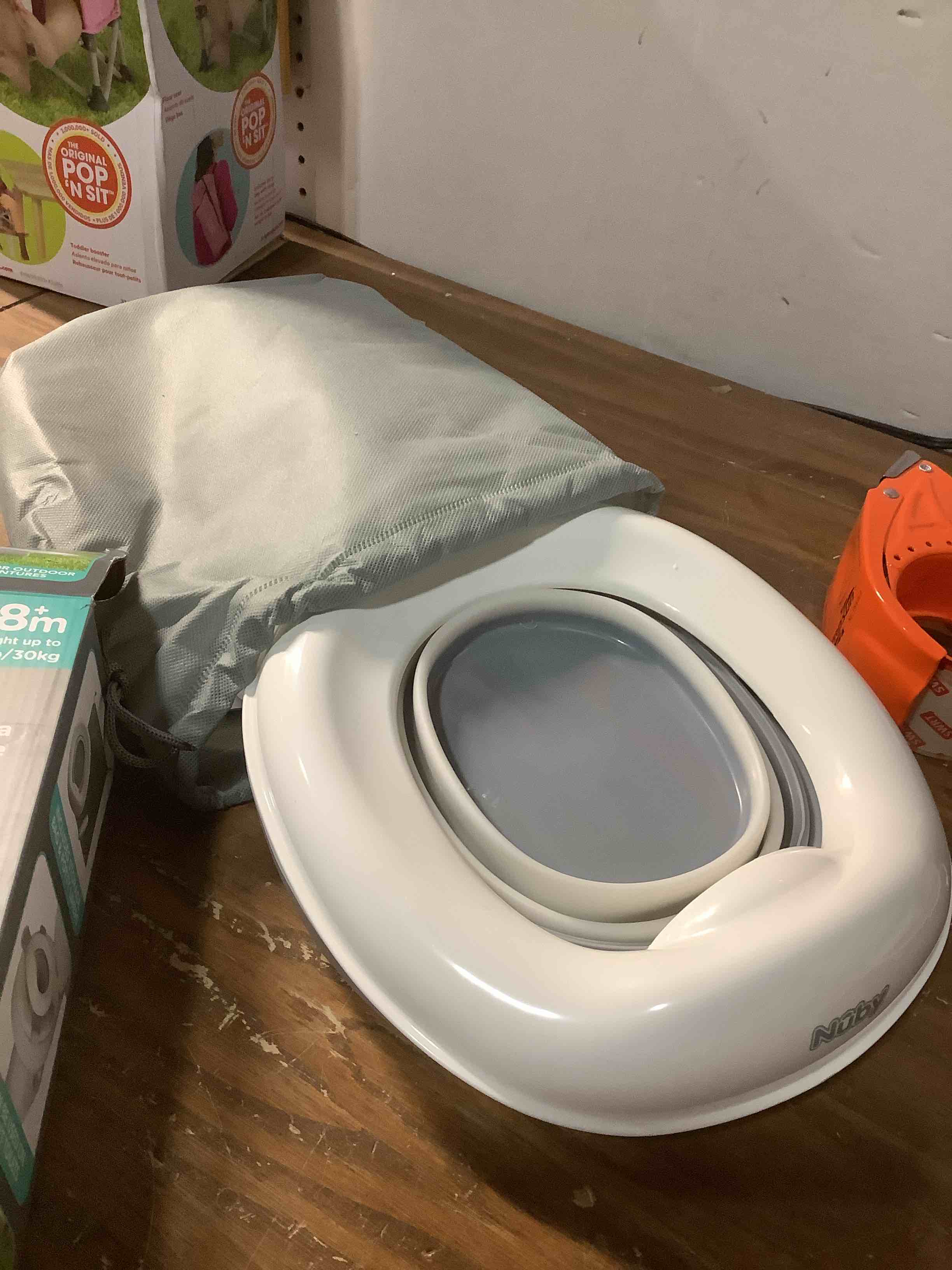 Condition photo showing As Is for Nuby On-The-Go Portable Potty Seat - Travel Toilet Seat for Boys and Girls 18+ Months - Includes Storage Bag and Disposable Potty Liners - Toddler Travel Essentials - Toddler Potty Training Toilet