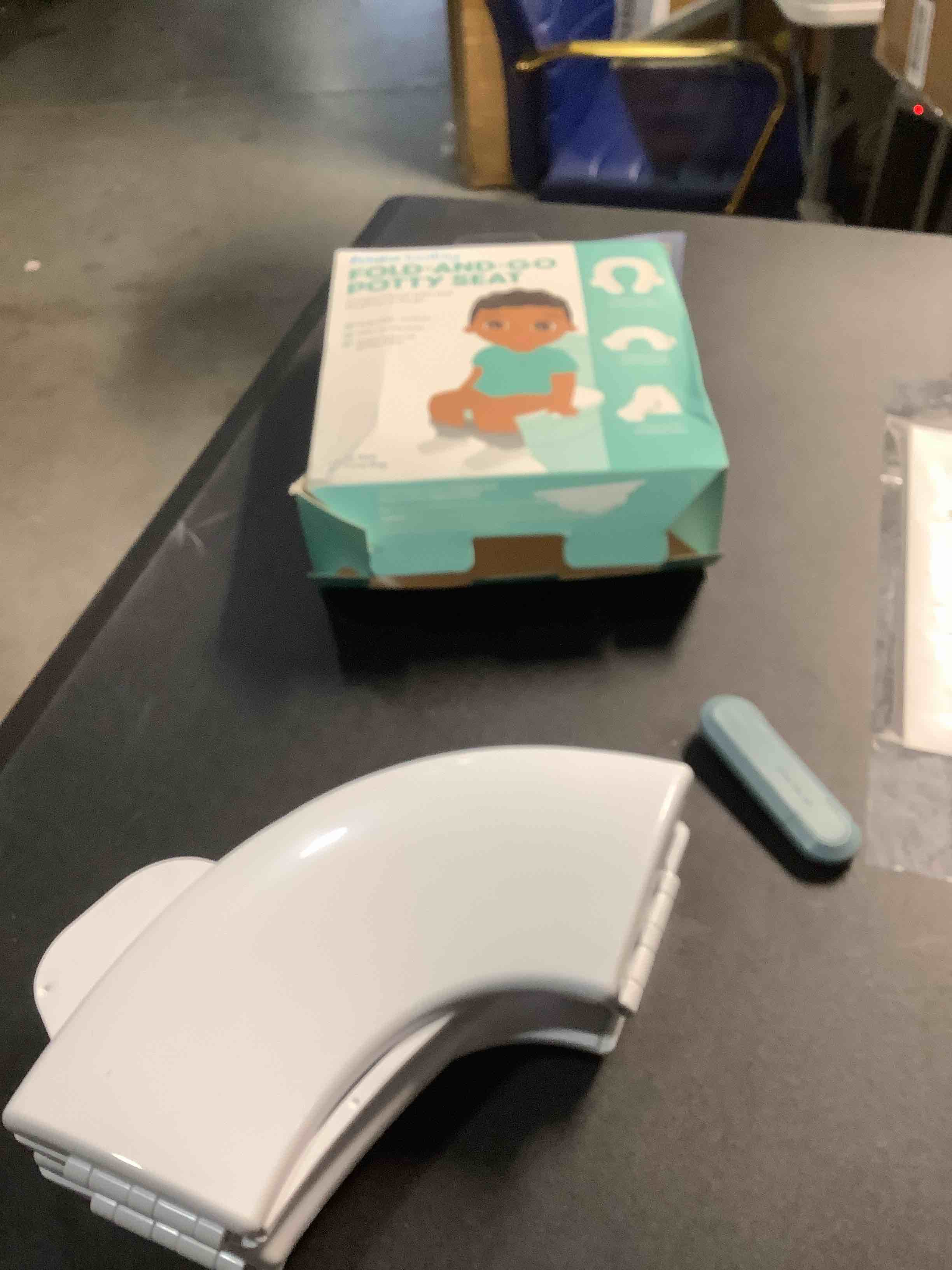 Condition photo showing Good Condition for Frida Baby Fold-and-Go Portable Potty Seat for Toilet, Foldable Travel Potty Seat for Toddler, Fits Round & Oval Toilets, Non-Slip Base, Handles, Includes Free Travel Bag Small