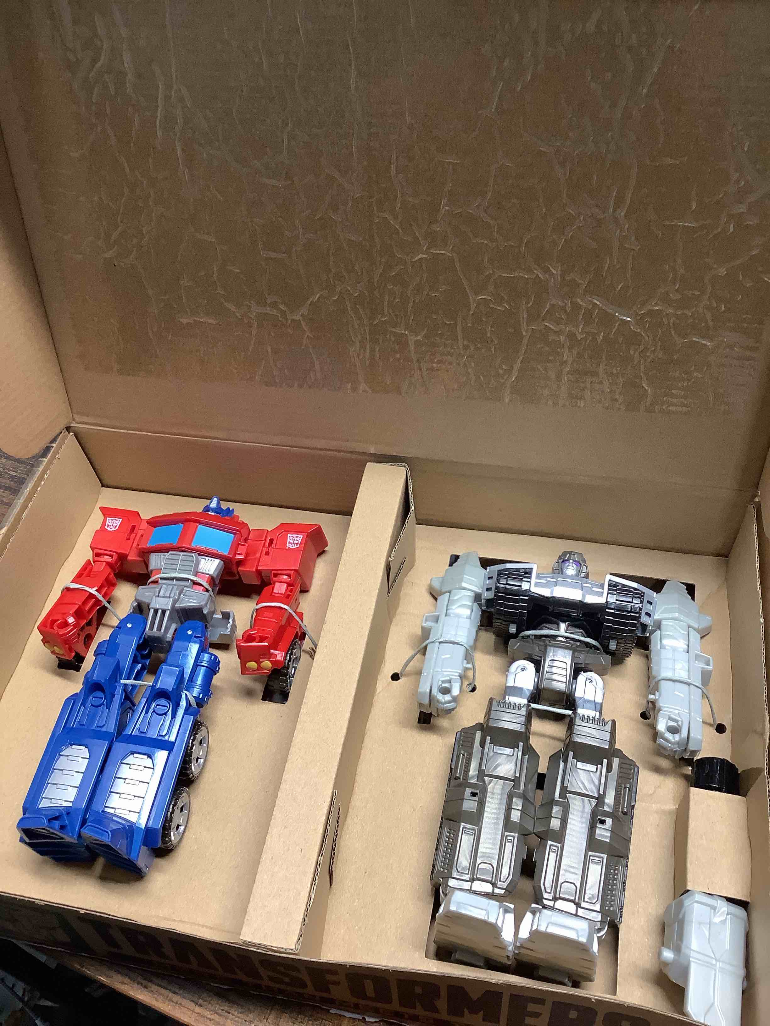 Condition photo showing Good Condition for Transformers Toys Heroes and Villains Optimus Prime and Megatron 2-Pack Action Figures - for Kids Ages 6 and Up, 7-inch (Amazon Exclusive) 7 Inch (Pack of 2)