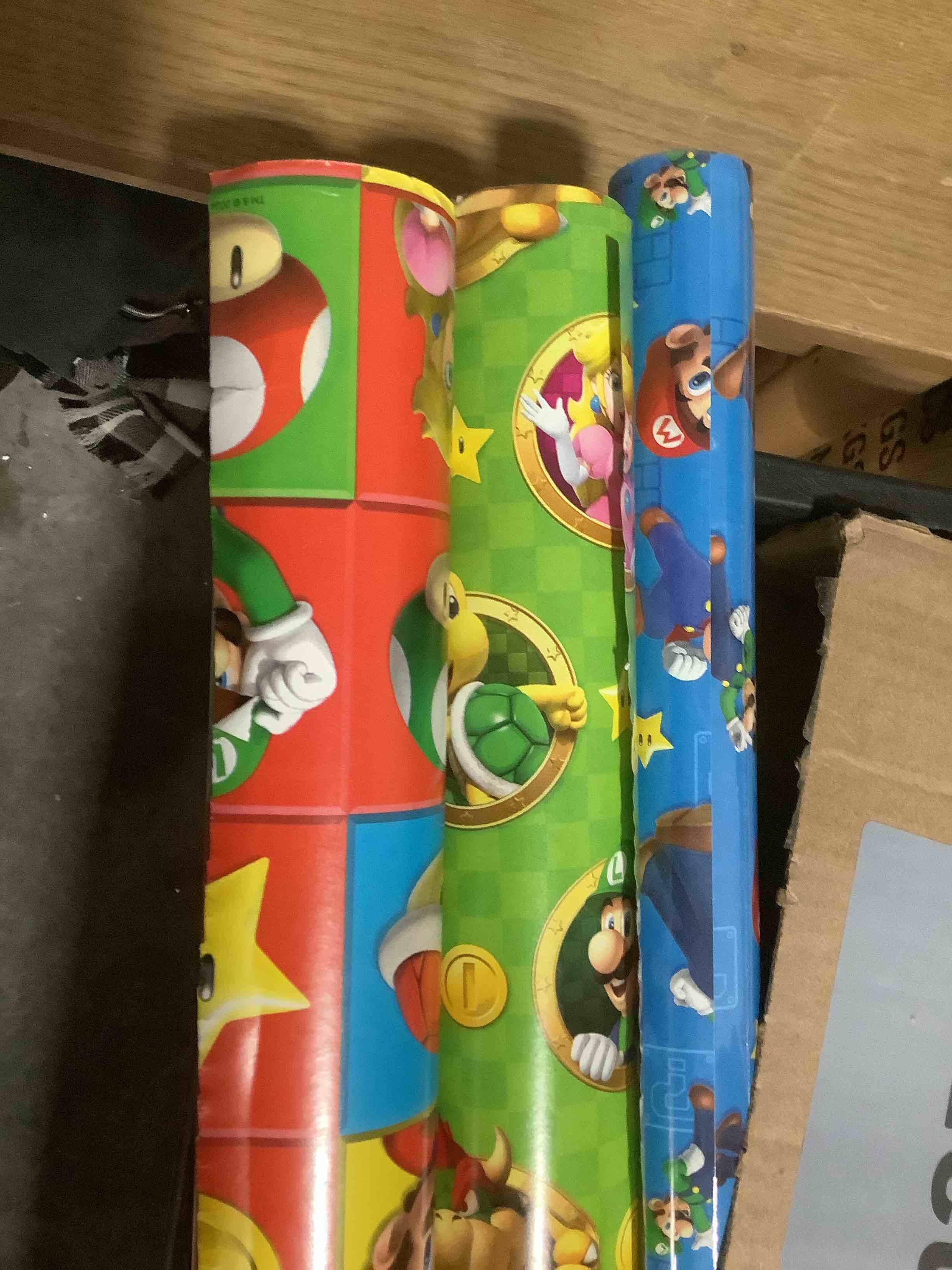 Condition photo showing As Is for Hallmark Nintendo Super Mario Wrapping Paper Rolls for Kids with Cutlines on Reverse (3 Rolls: 60 Sq. Ft. Total) Mario, Luigi, Yoshi, Bowser, Princess Peach, Toad