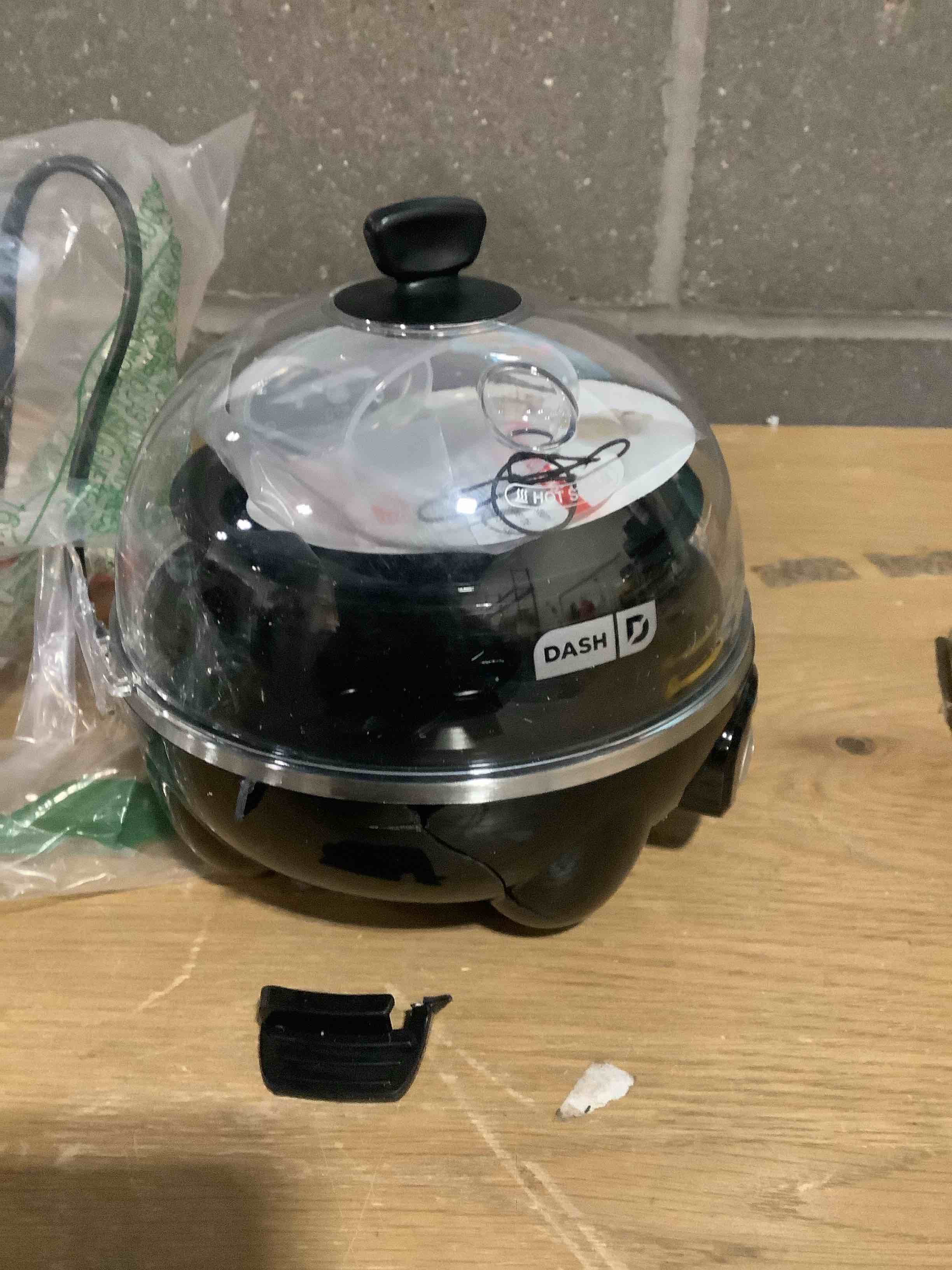 Condition photo showing As Is for Dash Rapid Egg Cooker - Boiler, Poacher & Steamer - Includes Measuring & Recipe Guide - Dishwasher Safe - BPA Free - Holds 7 Eggs, Black 7 Eggs Black