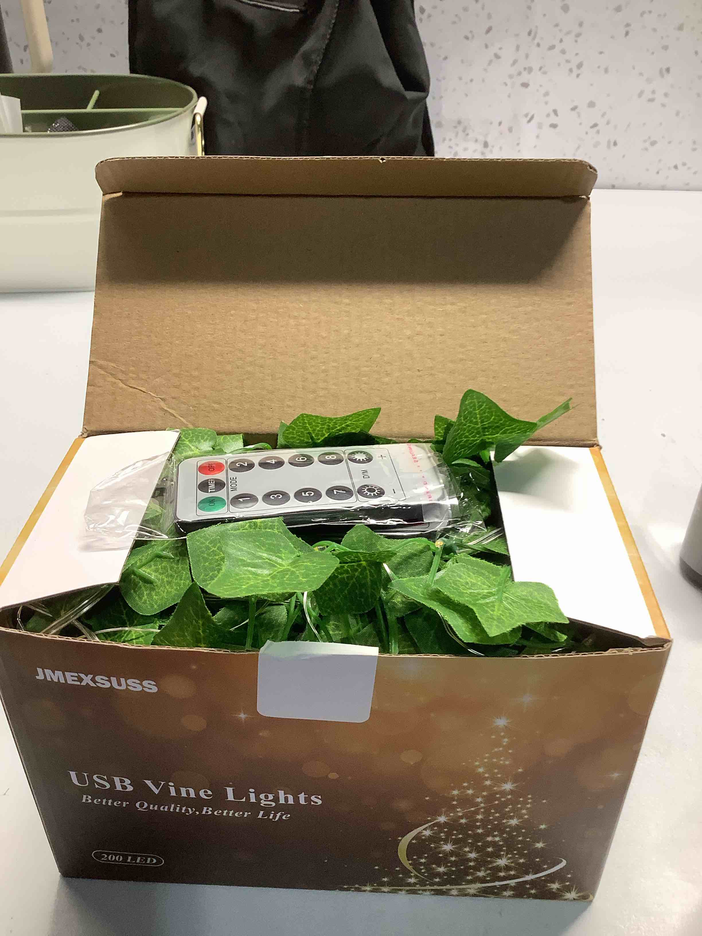 Condition photo showing Good Condition for JMEXSUSS Vines Lights for Bedroom, 200 LED Vines Fairy Lights, Artificial Ivy Leaf Light for Wall Curtain Wedding Party Christmas Indoor Decor, 6.5ft x 6.5ft with Remote 6.5x6.5ft - 200 LED