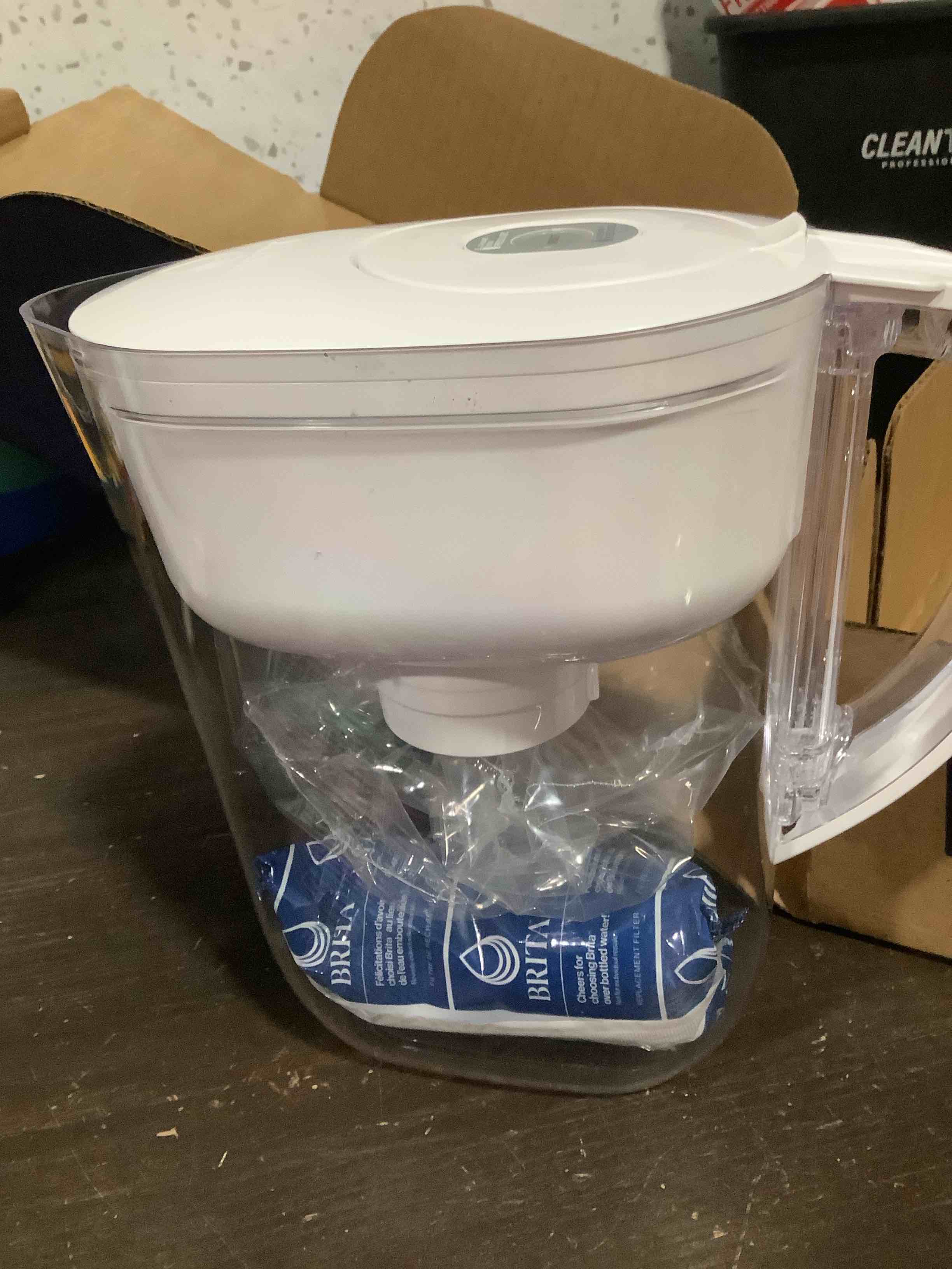 Condition photo showing As Is for brita water pitcher, metro elite filter, removes 99% of lead, includes 1 filter, 6-cup capacity, white elite filter white