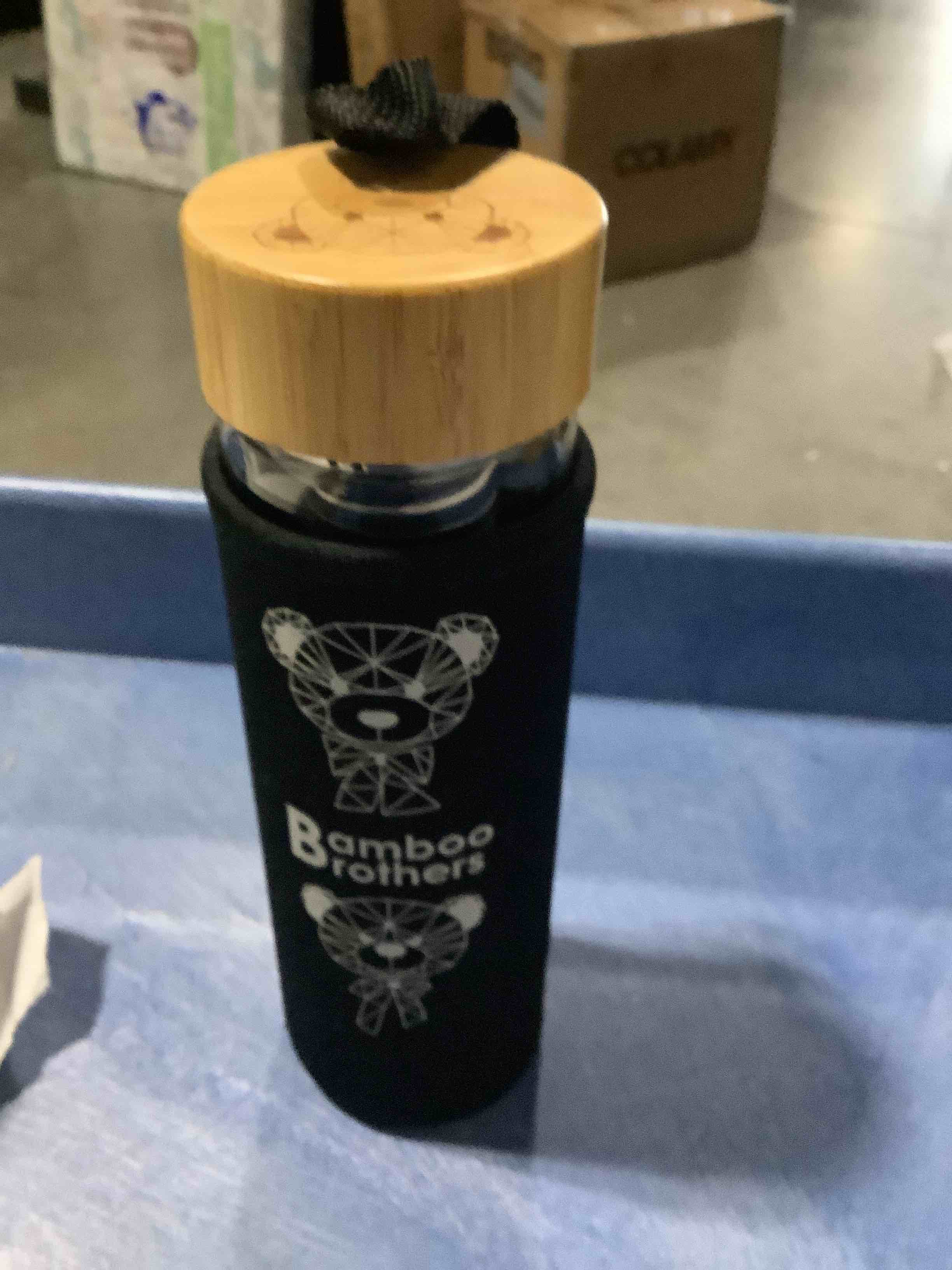 Condition photo showing New/Like New for bamboo brothers glass water bottle and tea infuser filter basket with bamboo lid and protective neoprene sleeve