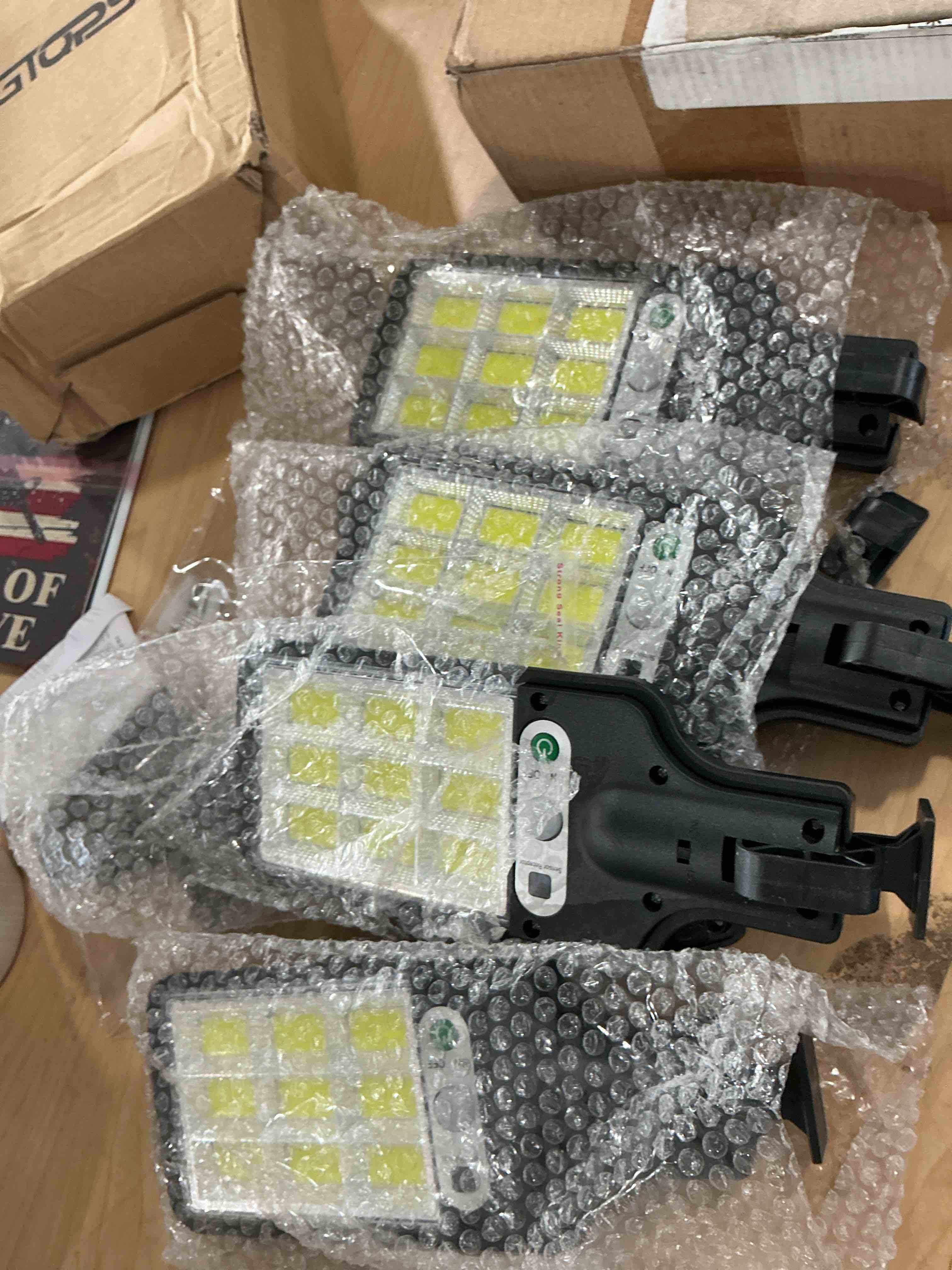 Condition photo showing New/Like New for 4 pack solar led outdoor light with remote control, wall mount, motion sensor, wireless