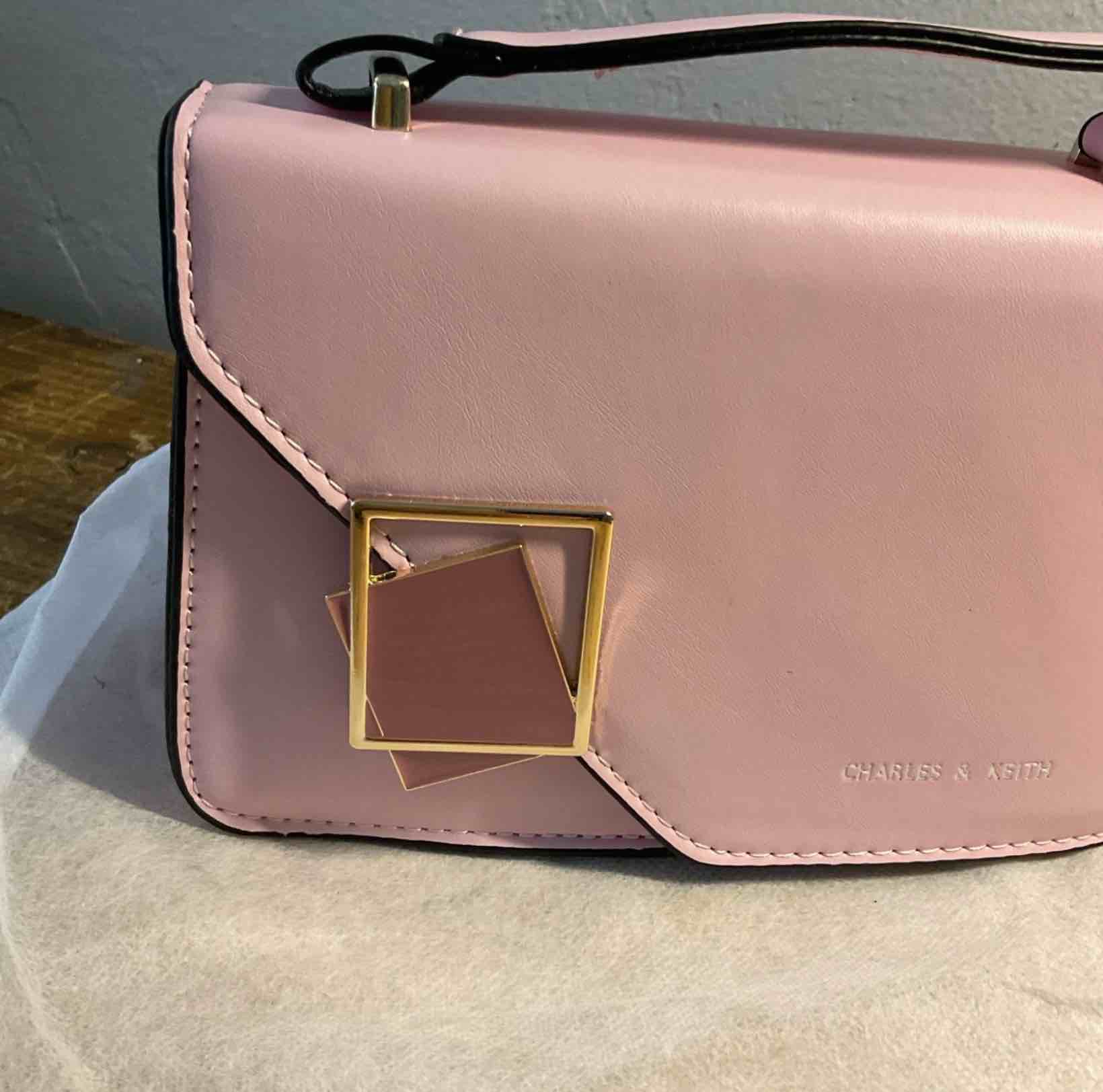 Condition photo showing New/Like New for charles & keith small pink handbag new clutch