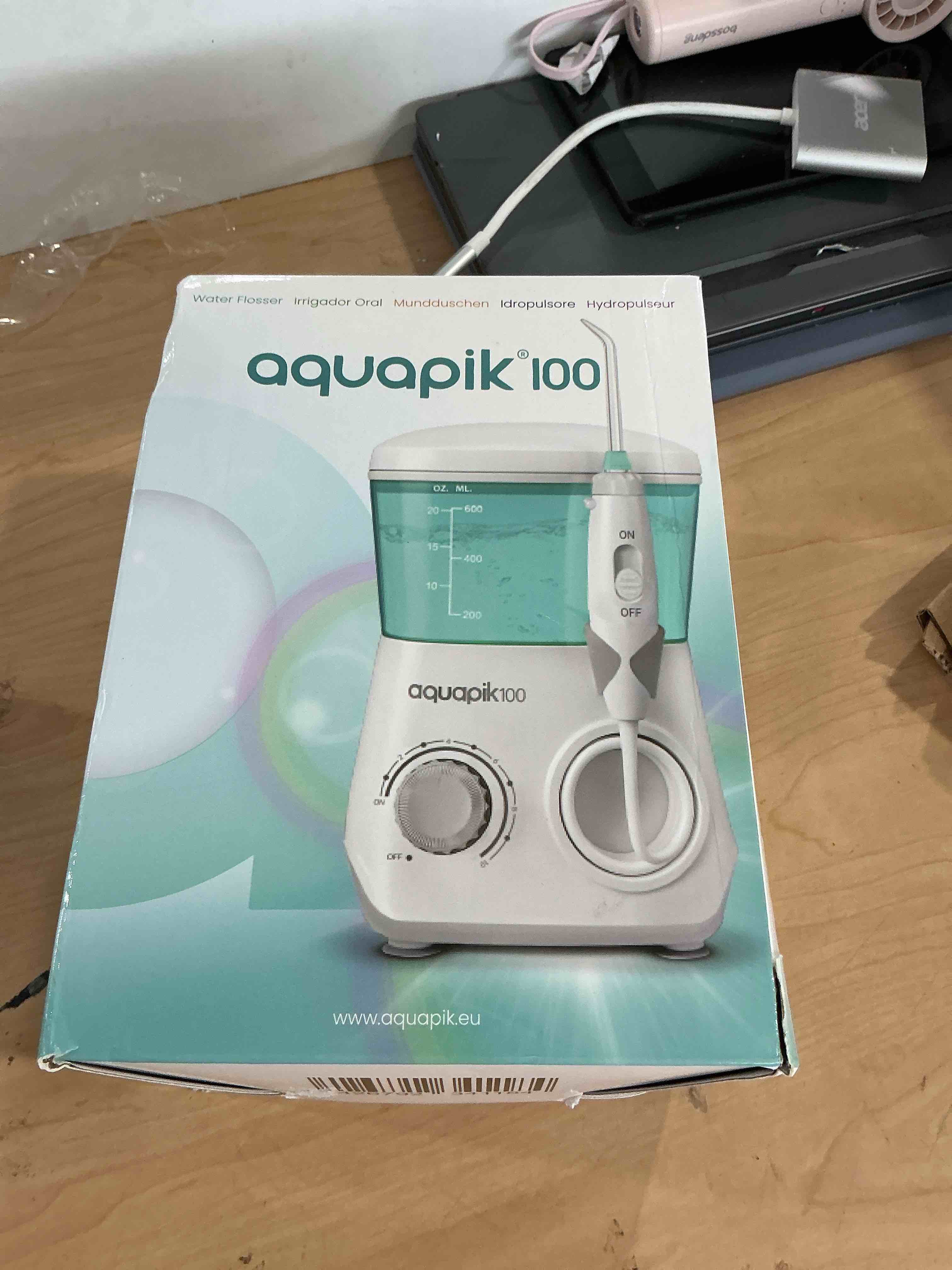 Condition photo showing New/Like New for bostontech aquapik 100 countertop water flosser for teeth, 600 ml corded oral irrigator with 10 pressure levels, 8 nozzles including nasal tip, 360° tip, for braces, implants, gums, white