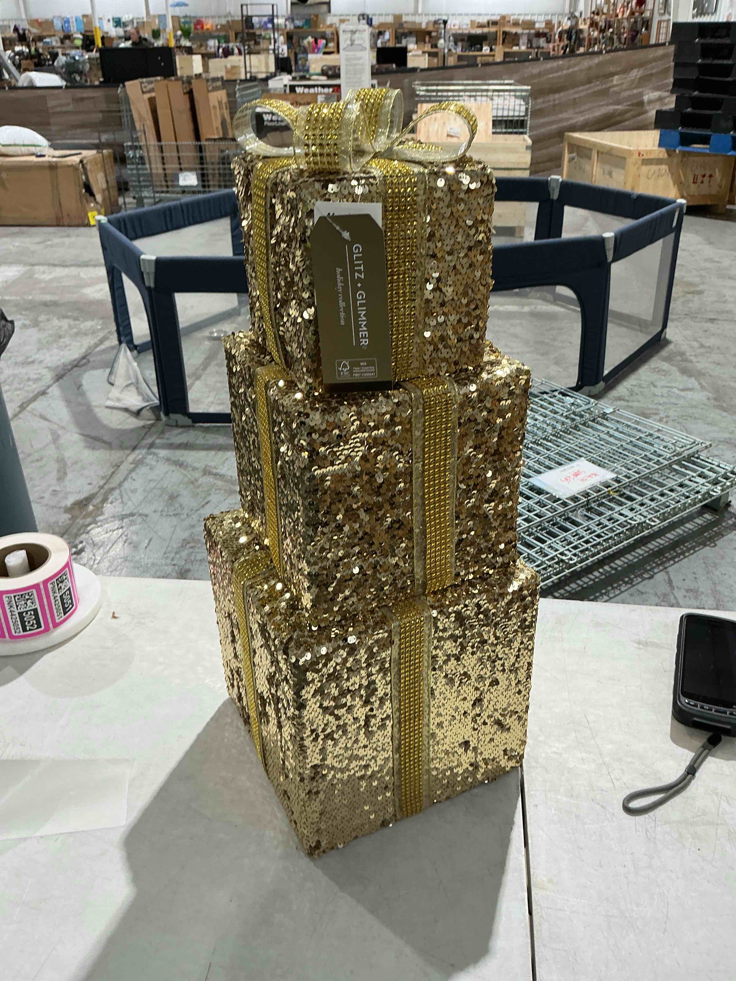 glitz and glimmer Holiday collection stacked gold gift boxes