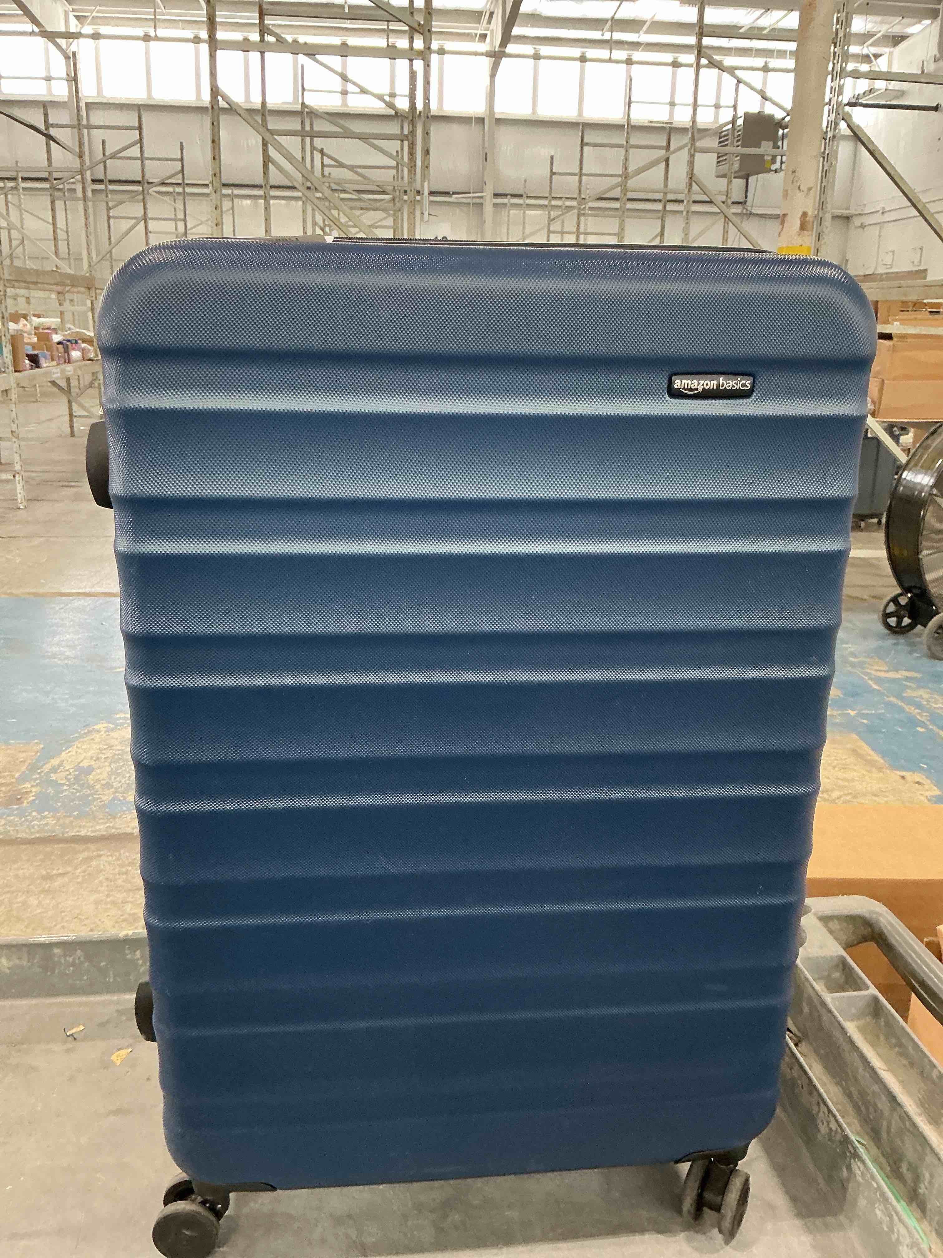 Condition photo showing New/Like New for amazon basics 30" hardside large checked luggage, expandable for up to 15% more space, with scratch-resistant surface, four multi-directional wheels, telescoping handle, navy blue large checked