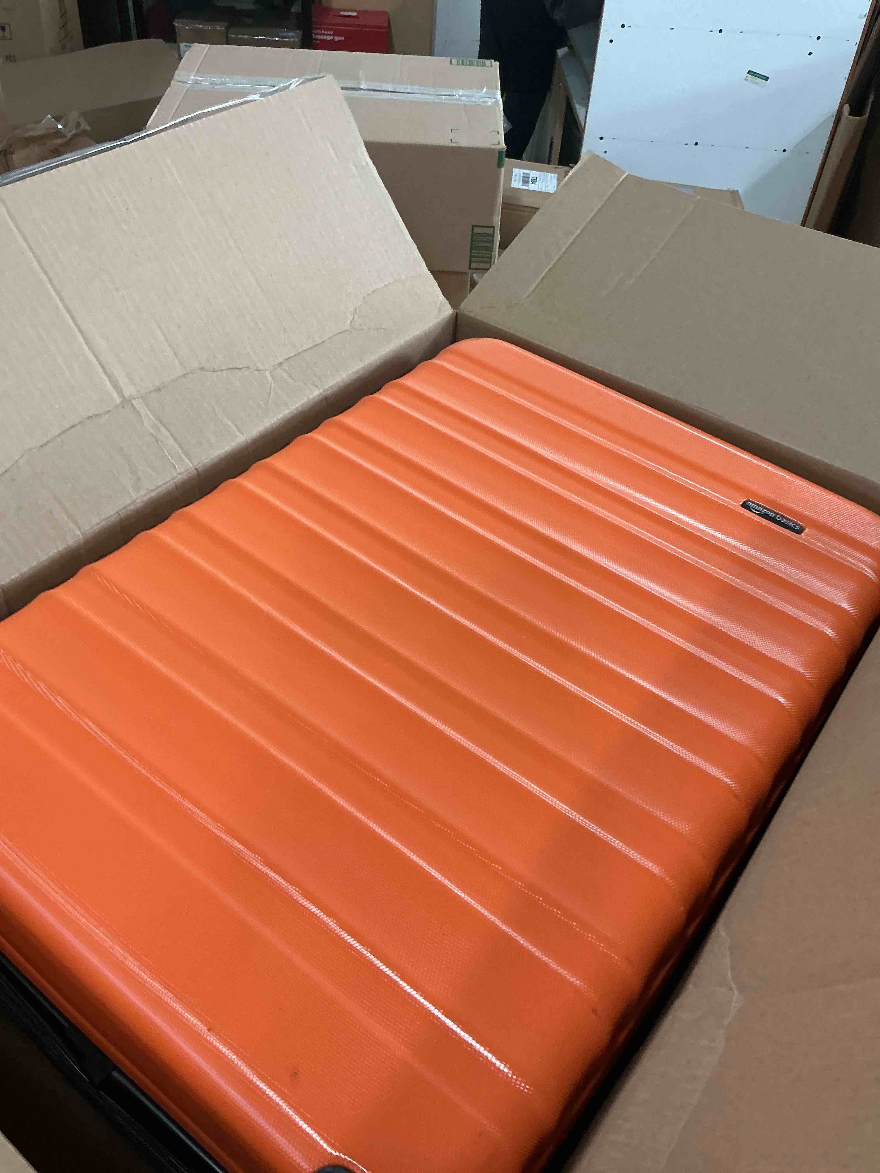 Condition photo showing New/Like New for amazon basics 26" hardside medium checked luggage, hardshell suitcase with wheels, expandable for up to 15% more space, with scratch-resistant surface, four multi-directional wheels, orange orange medium checked