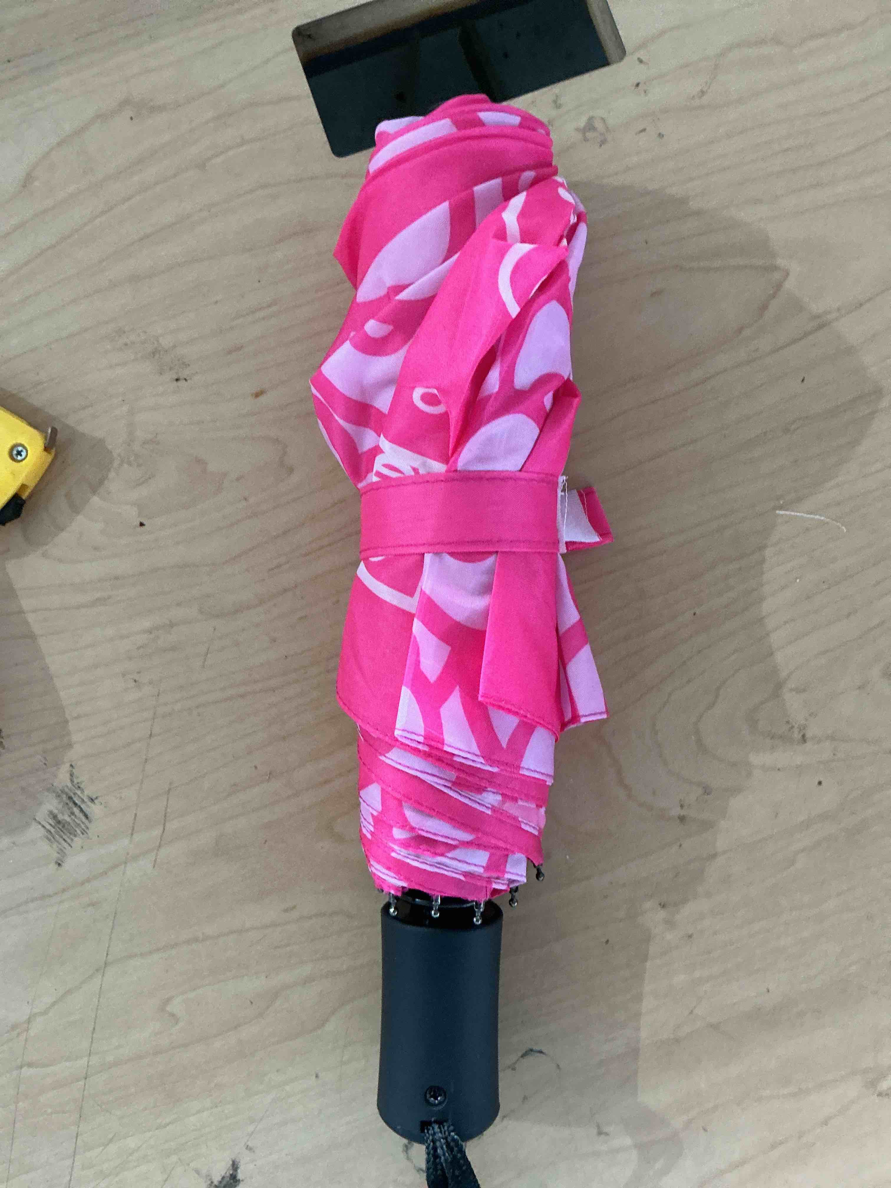Condition photo showing New/Like New for hello kitty umbrella, allover head print, compact travel, automatic open and close, with matching sleeve, pink
