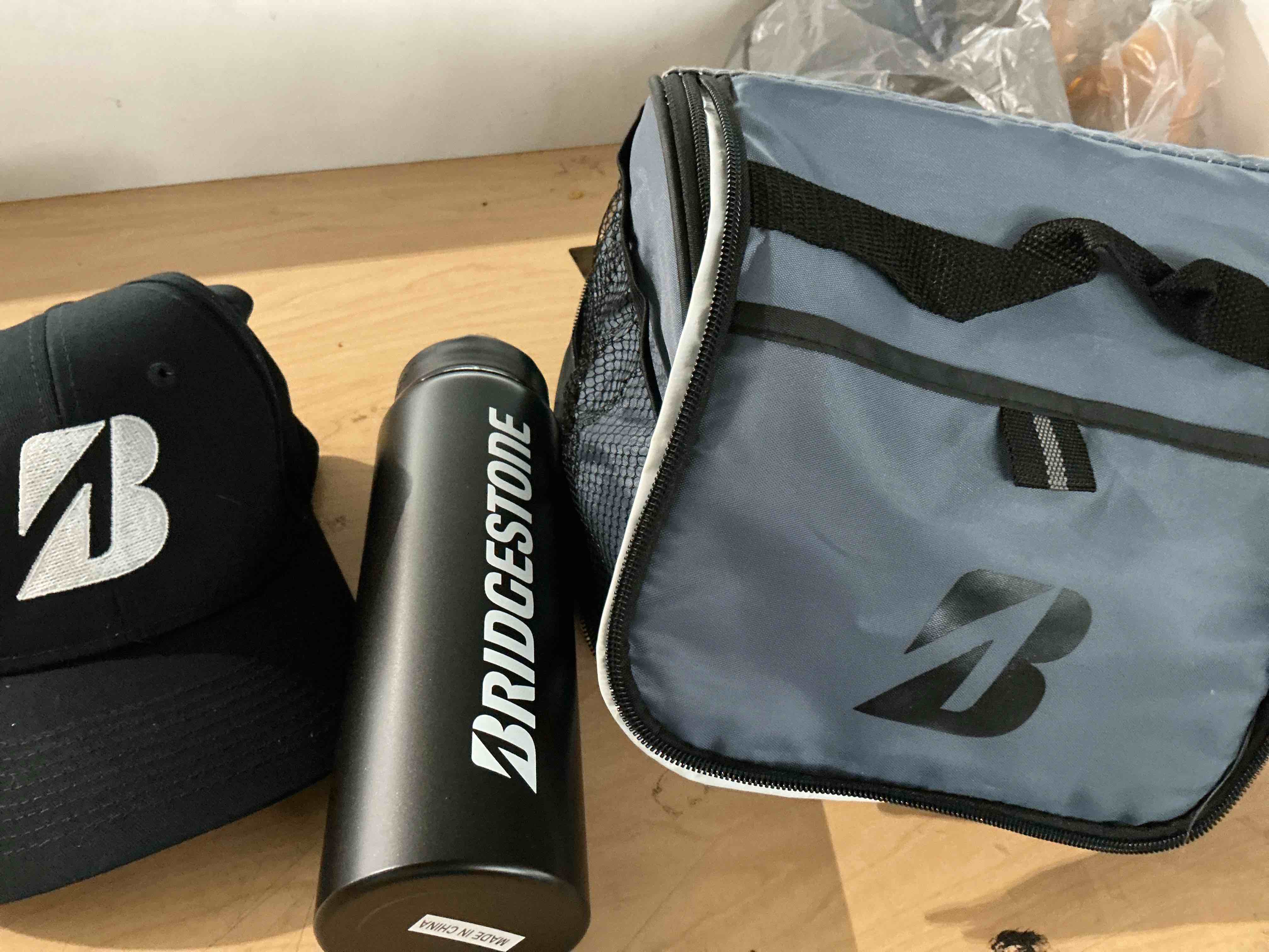 Condition photo showing New/Like New for bridgestone kit includes a cooler bag, structured cap and aluminum water bottle