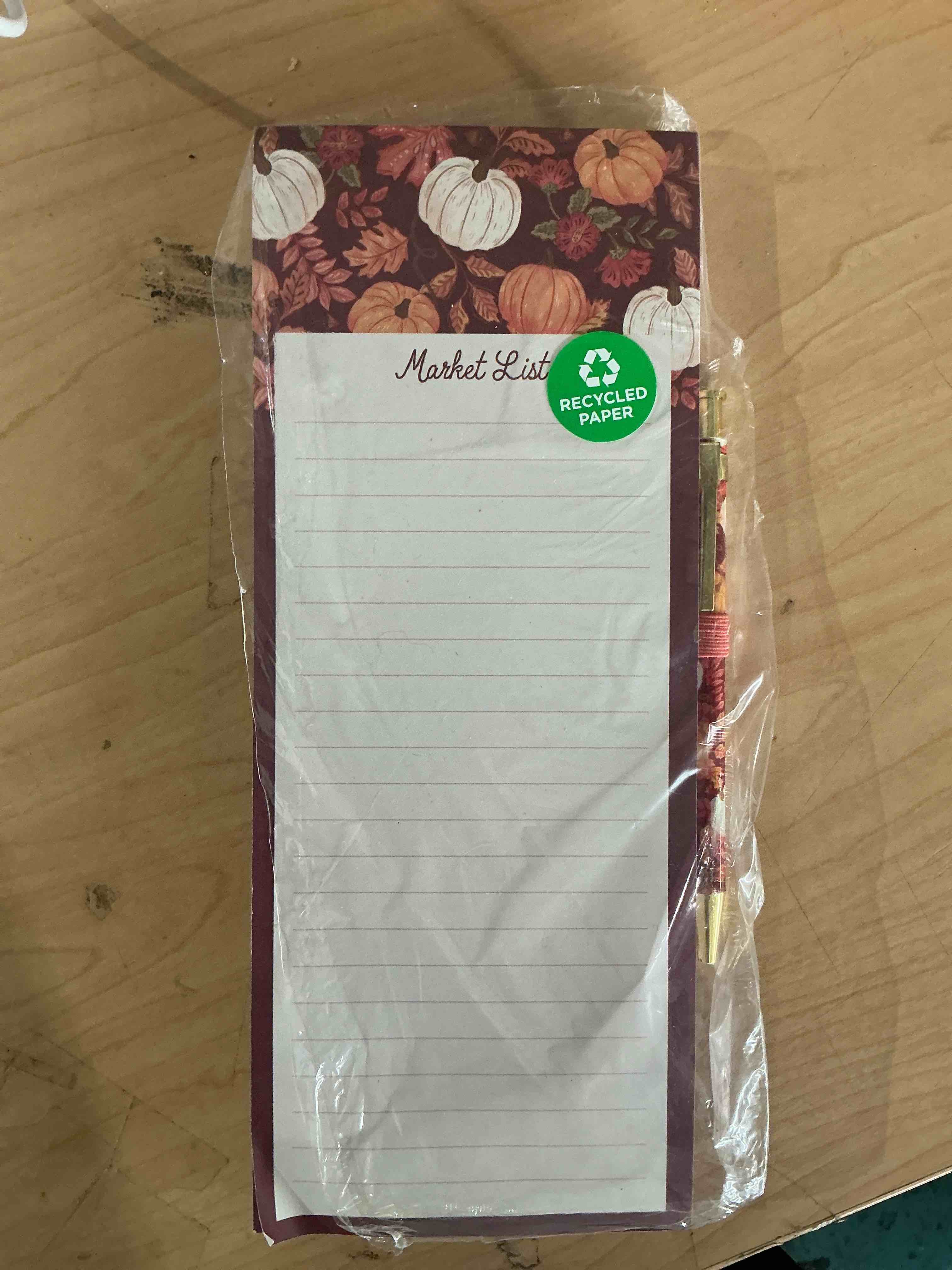 Condition photo showing New/Like New for fall -themed market list notepad set features a pumpkin and autumn leaf design includes a matching pen and a magnetic bag for attaching to metal surfaces like refrigerator refrigerators