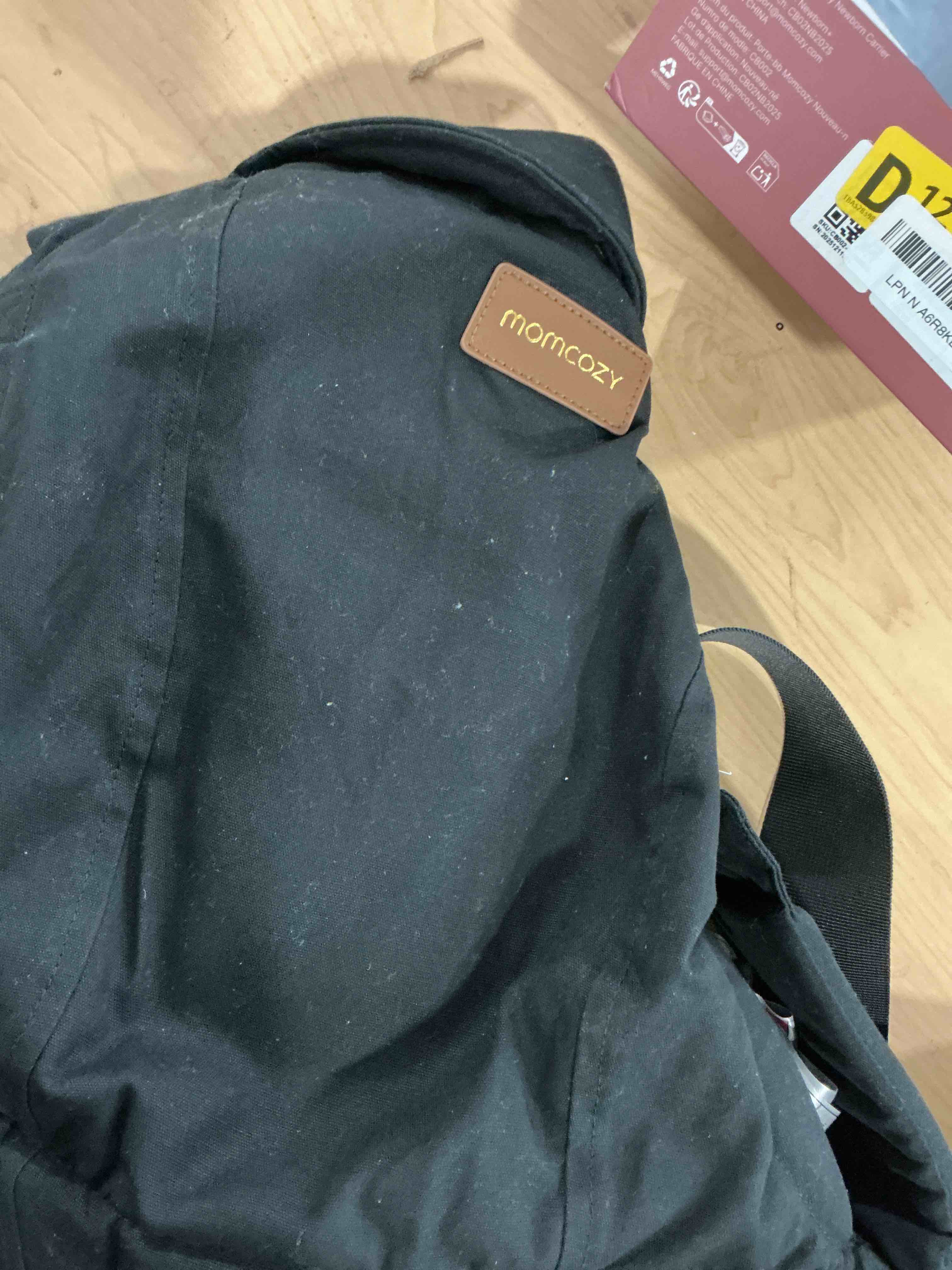 Condition photo showing Good Condition for Momcozy Newborn Carrier WeeSnug- Lightweight and Cozy Comfort for 7-25 lbs, Ergonomic Cross-Back Support, Effortless to Put On, Hands-Free Baby Carrier with Lumbar Support, Black