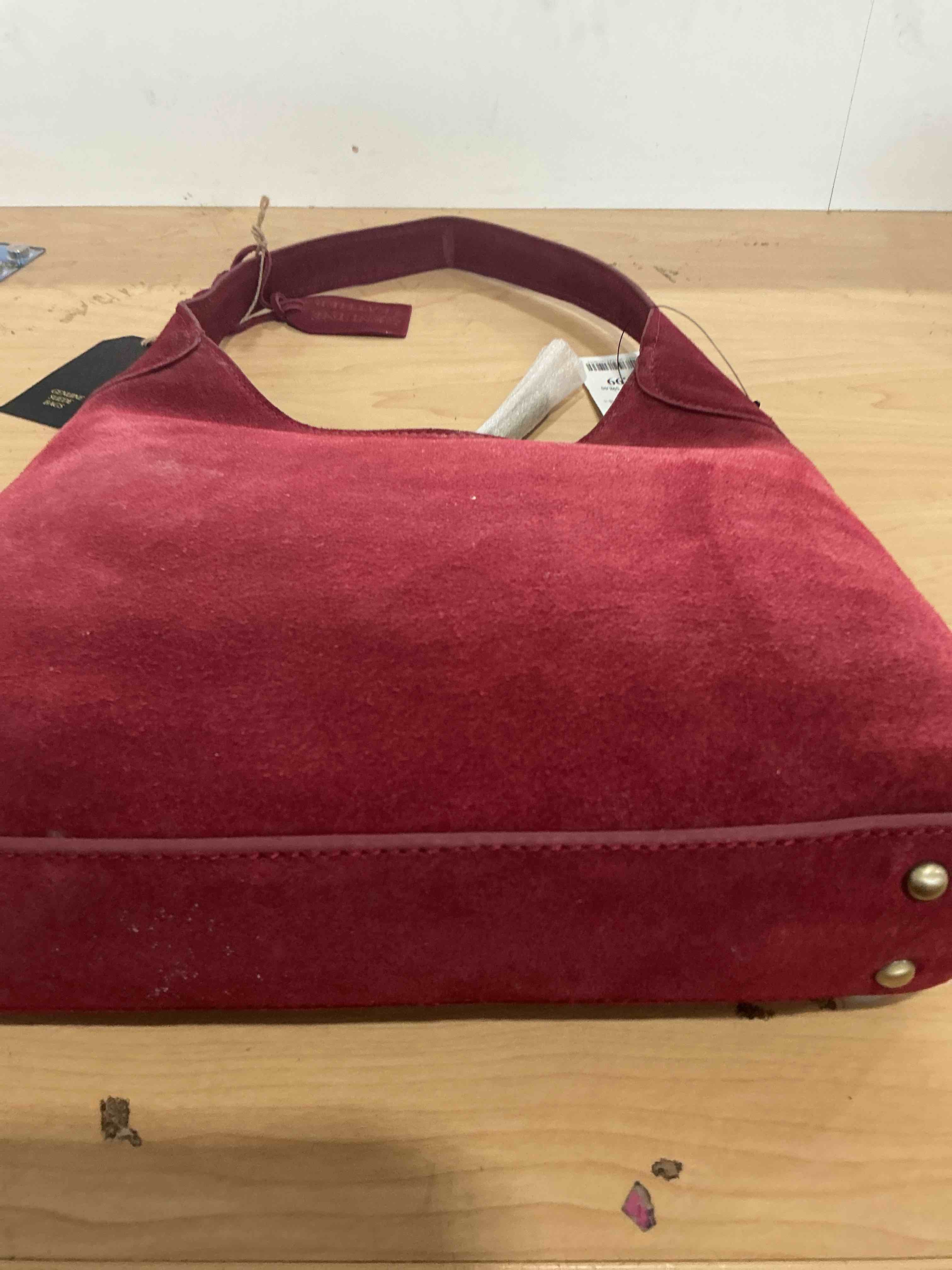 Condition photo showing New/Like New for red, genuine, suede leather handbag with gold accent