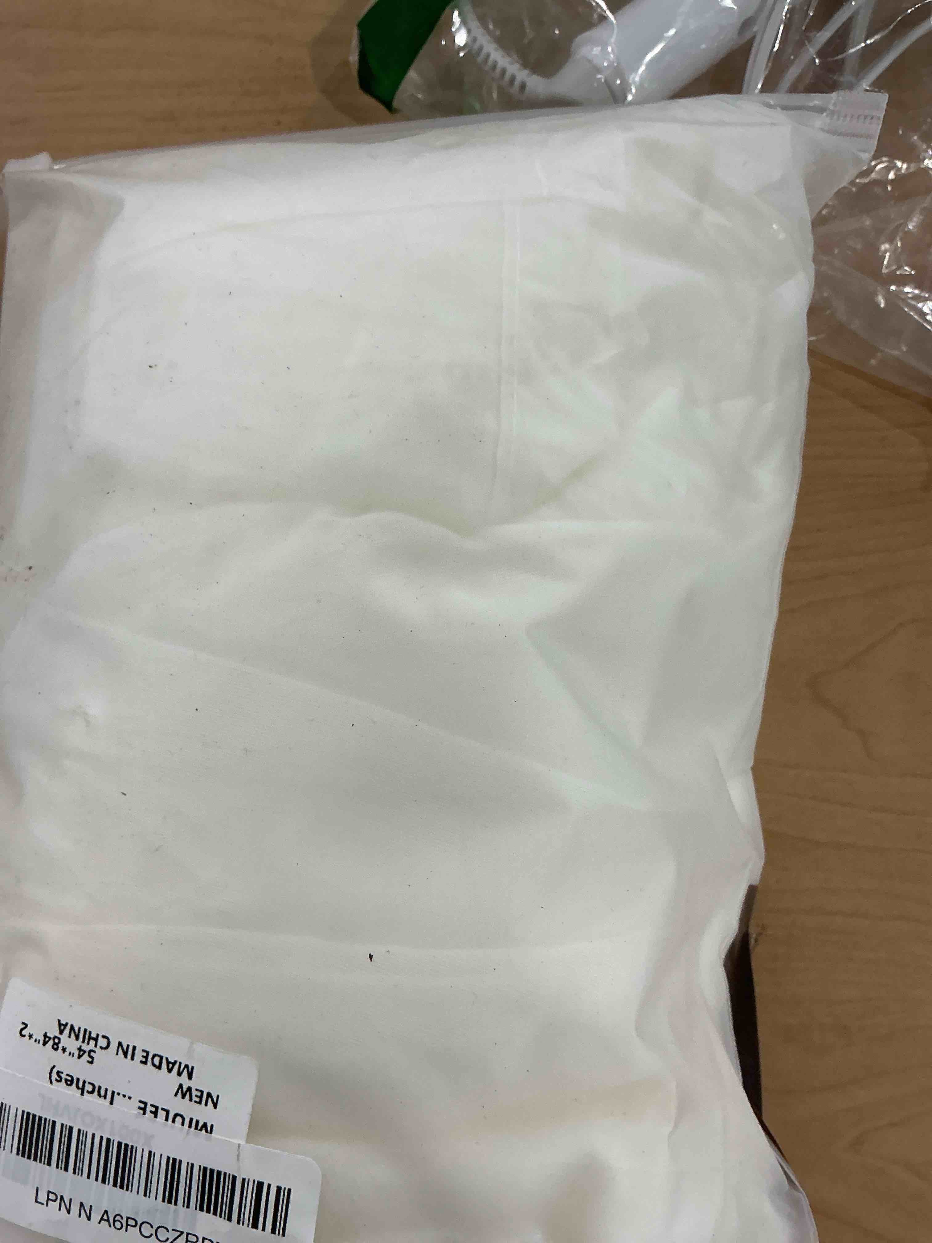 Condition photo showing New/Like New for MIULEE 2 Panels Solid Color Ivory Sheer Curtains Elegant Grommet Top Window Voile Panels/Drapes/Treatment for Bedroom Living Room (54X84 Inches) Ivory 54"W x 84"L (Pack of 2)