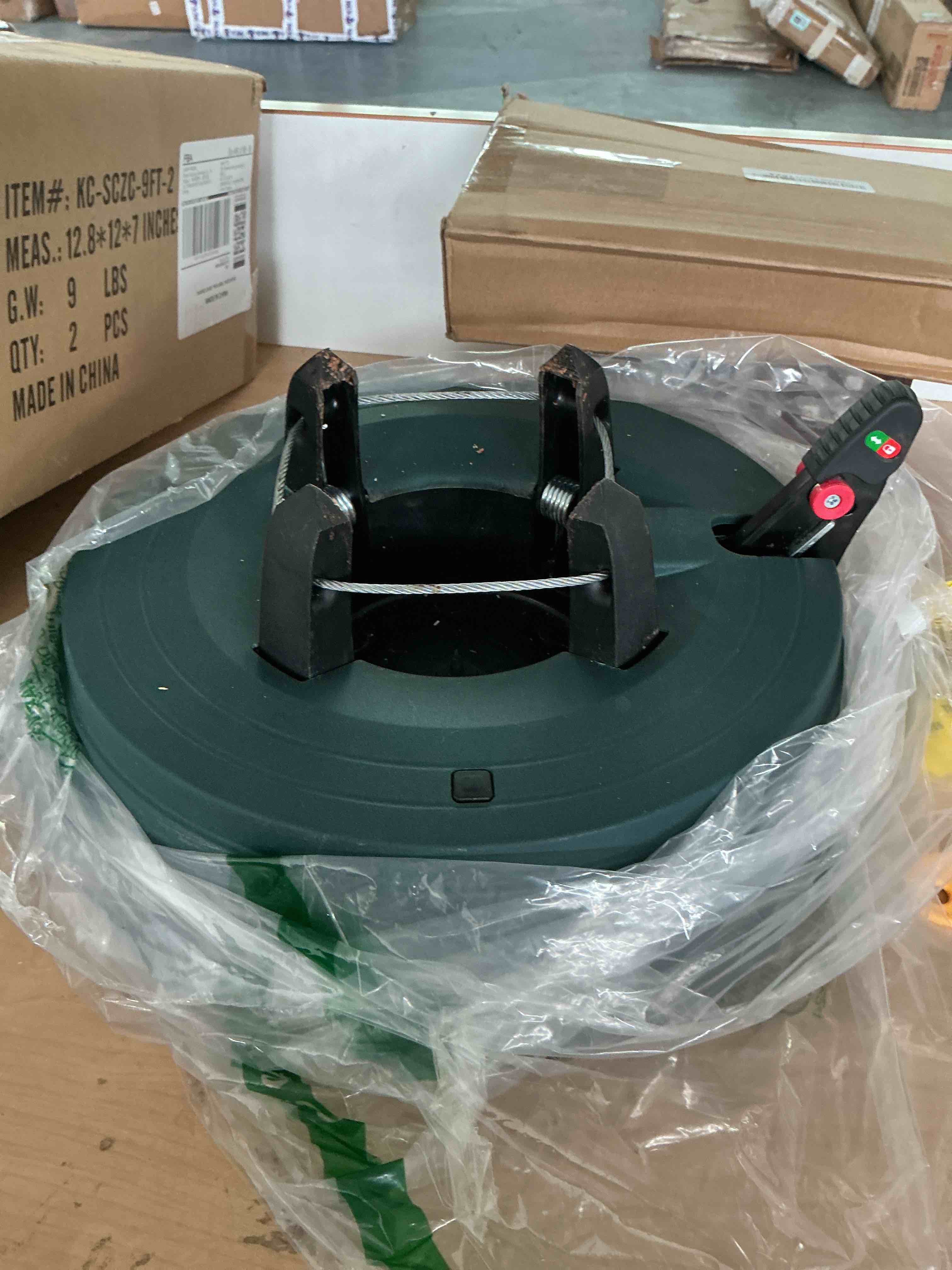 Condition photo showing New/Like New for automatic christmas tree stand for real trees, green plastic holiday tree base with foot pedal, easy single cable operation, water reservoir & level indicator