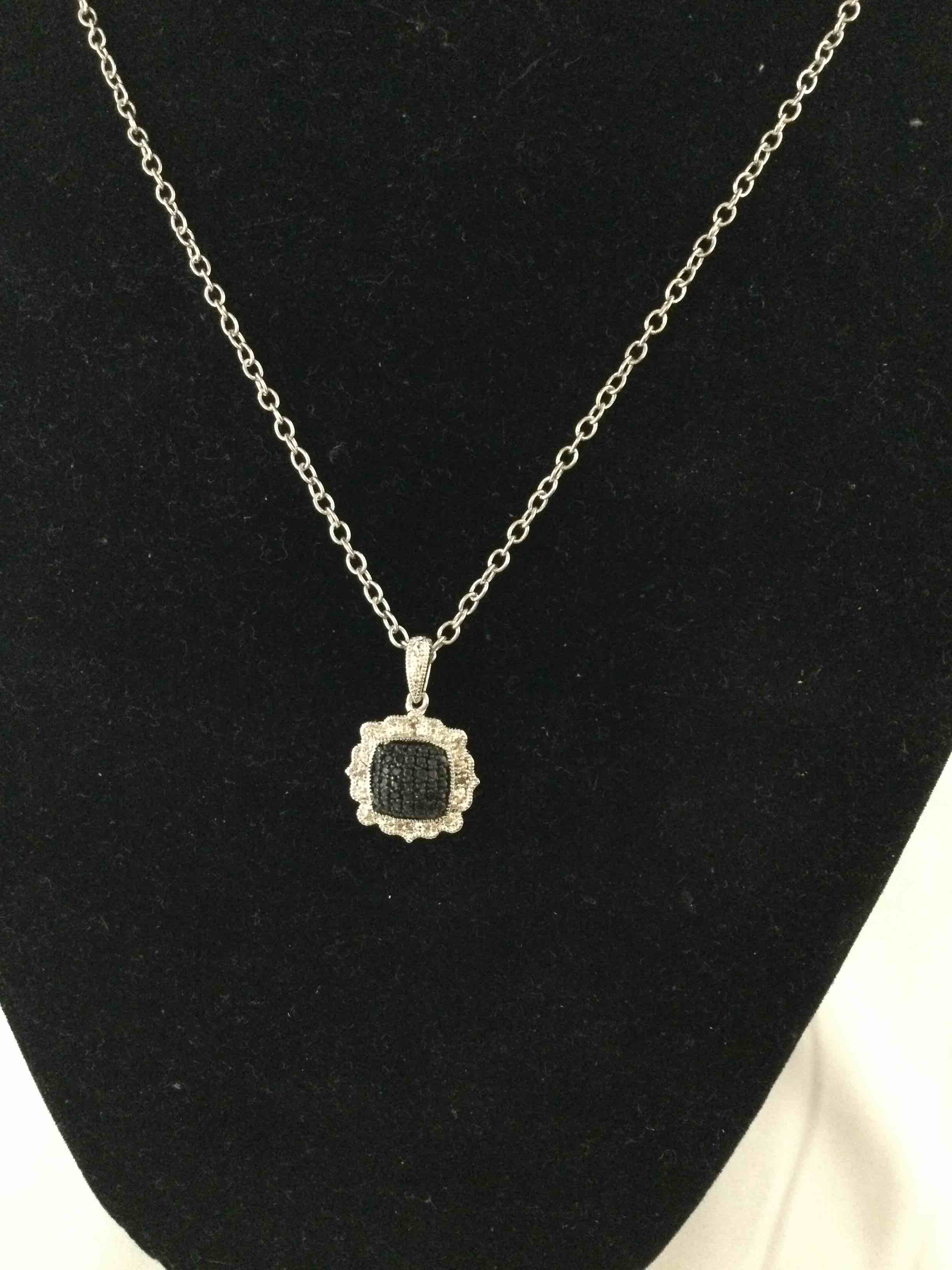 Condition photo showing New/Like New for black and white diamond necklace