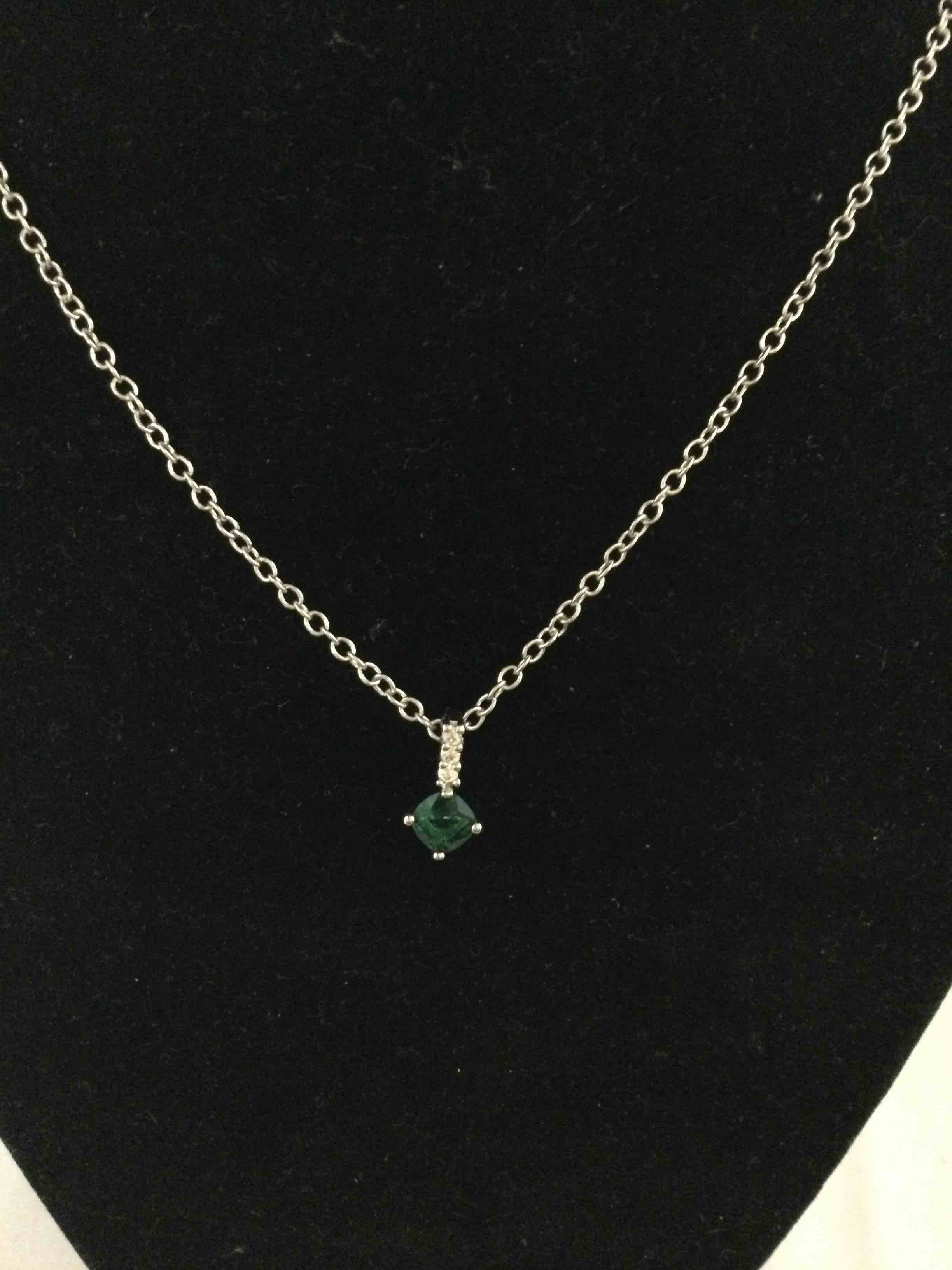 Condition photo showing New/Like New for emerald and white topaz necklace