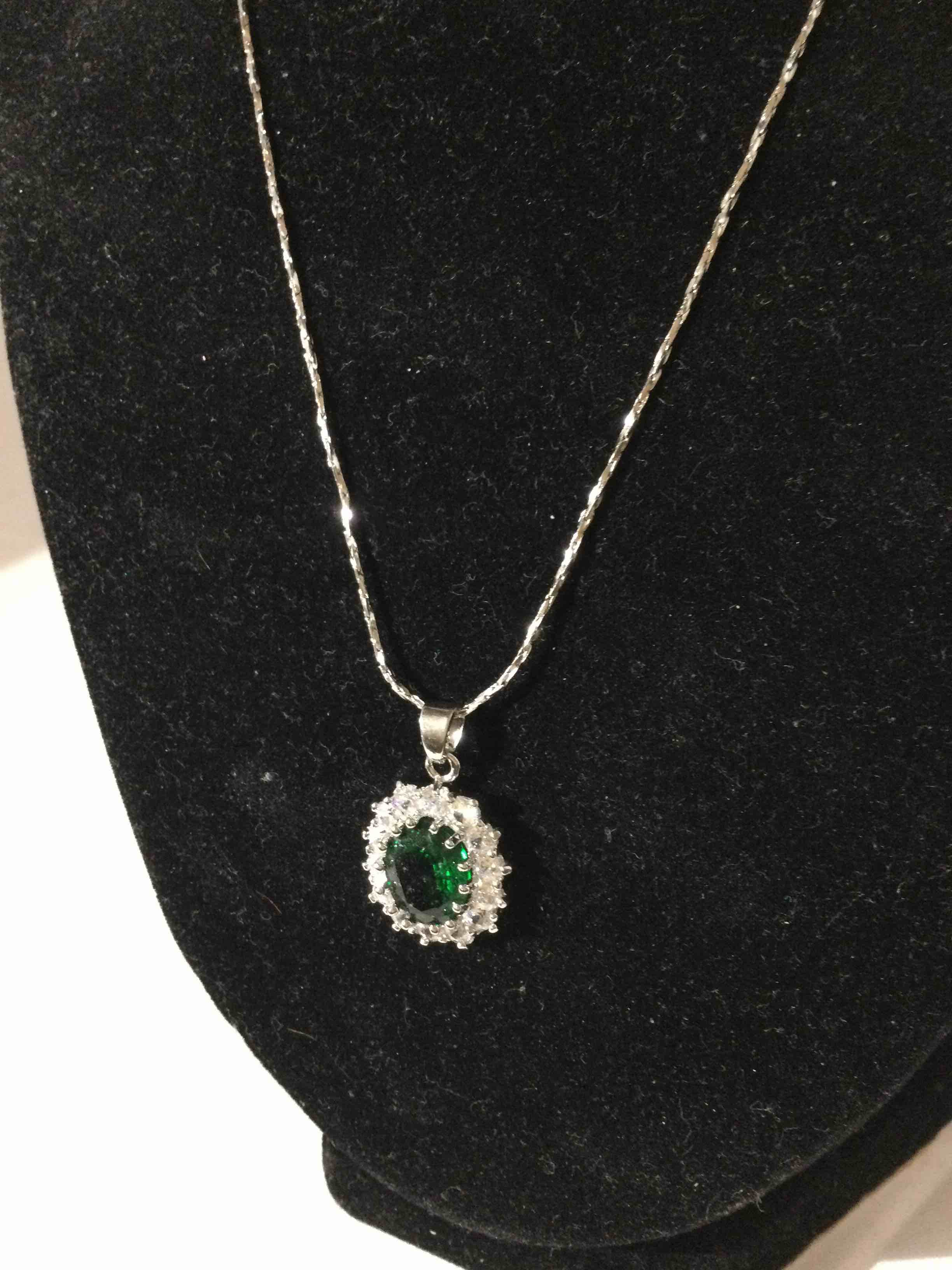 Condition photo showing New/Like New for emerald and white topaz necklace