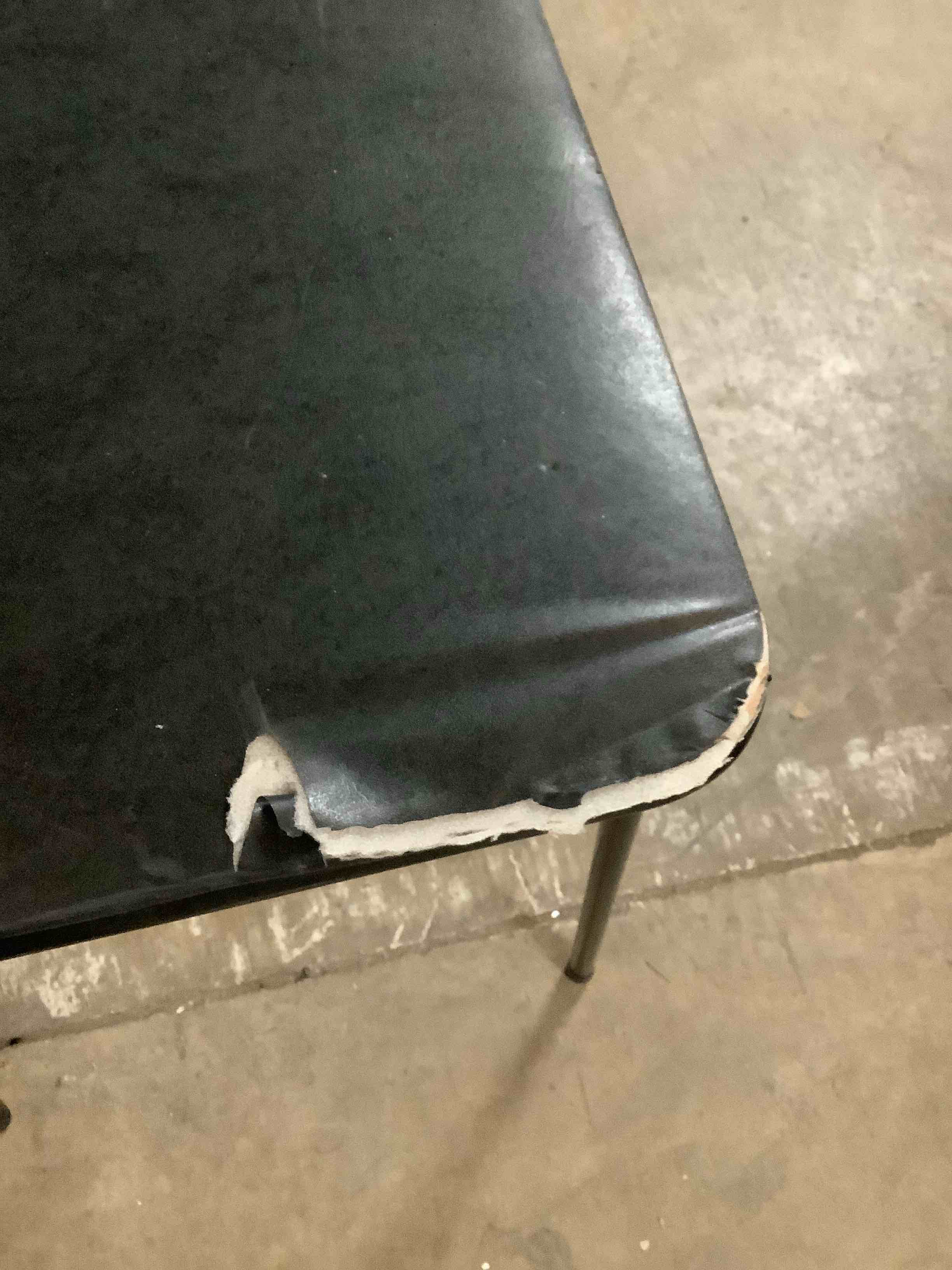 Condition photo showing Good Condition for Damaged Black Card Table approximately 2’x5’ Rectangular.