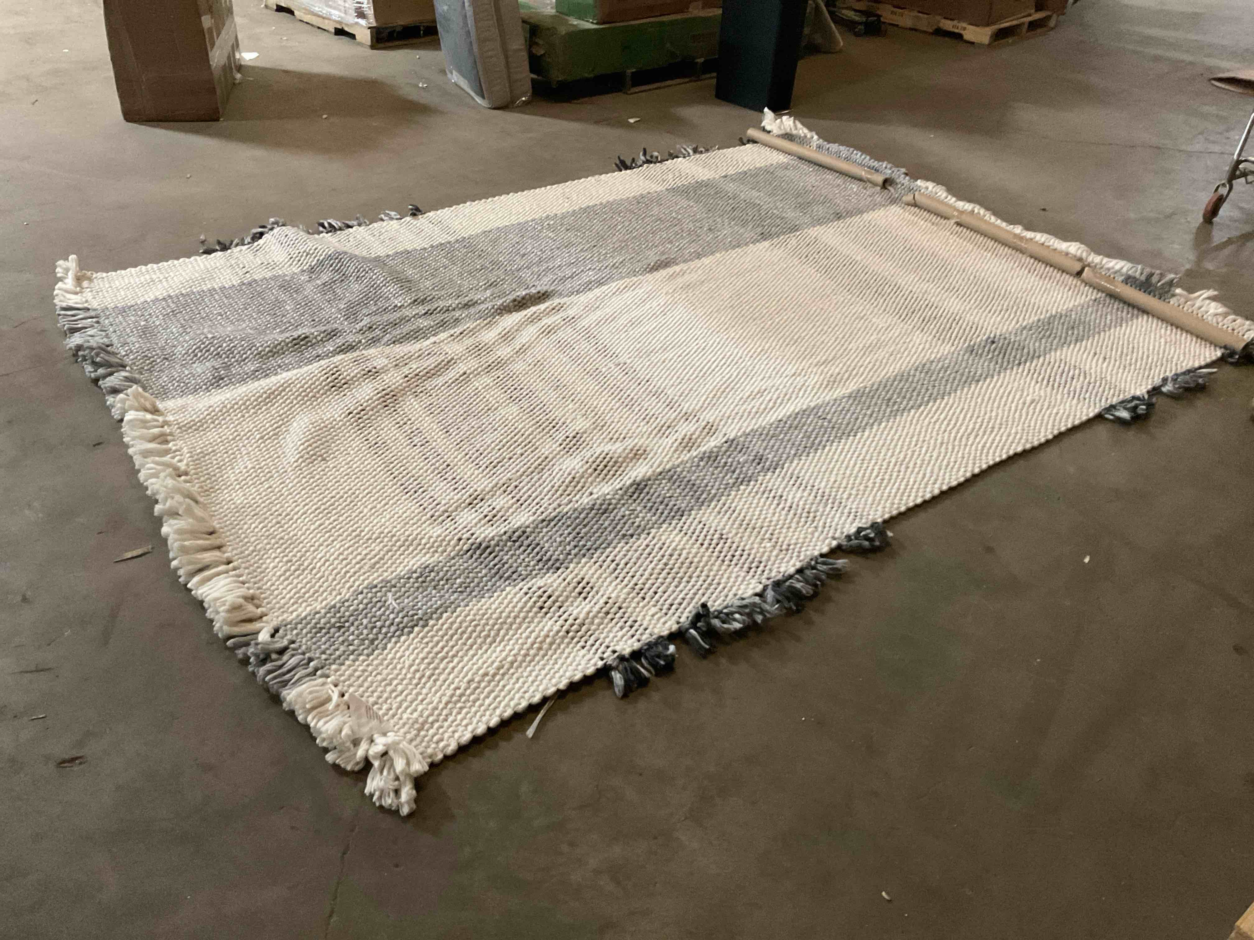 Condition photo showing Good Condition for Grey and White Striped Rug with Tassels