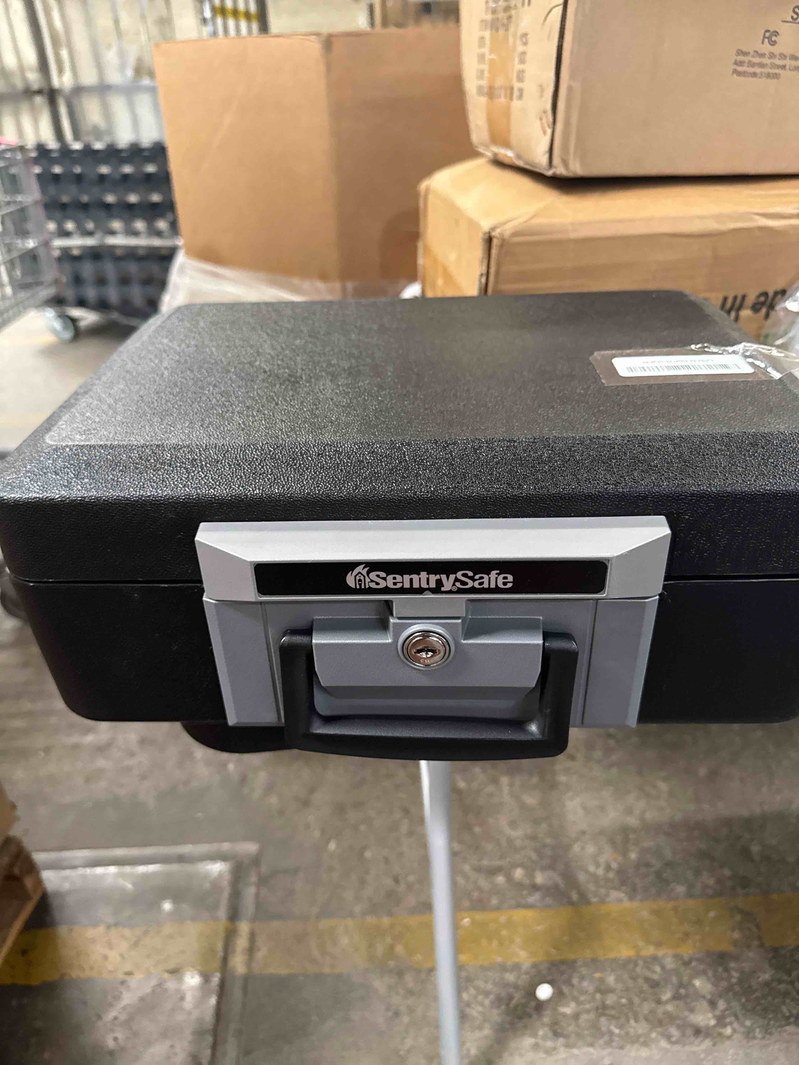 Condition photo showing As Is for (half a key stuck inside lock)sentrysafe fireproof safe box with key lock, chest safe with carrying handle to secure money, jewelry, documents, 0.25 cubic feet, 6.3 x 15.3 x 12.1 inches, 1160 fire resistant box 0.25 cu. ft.